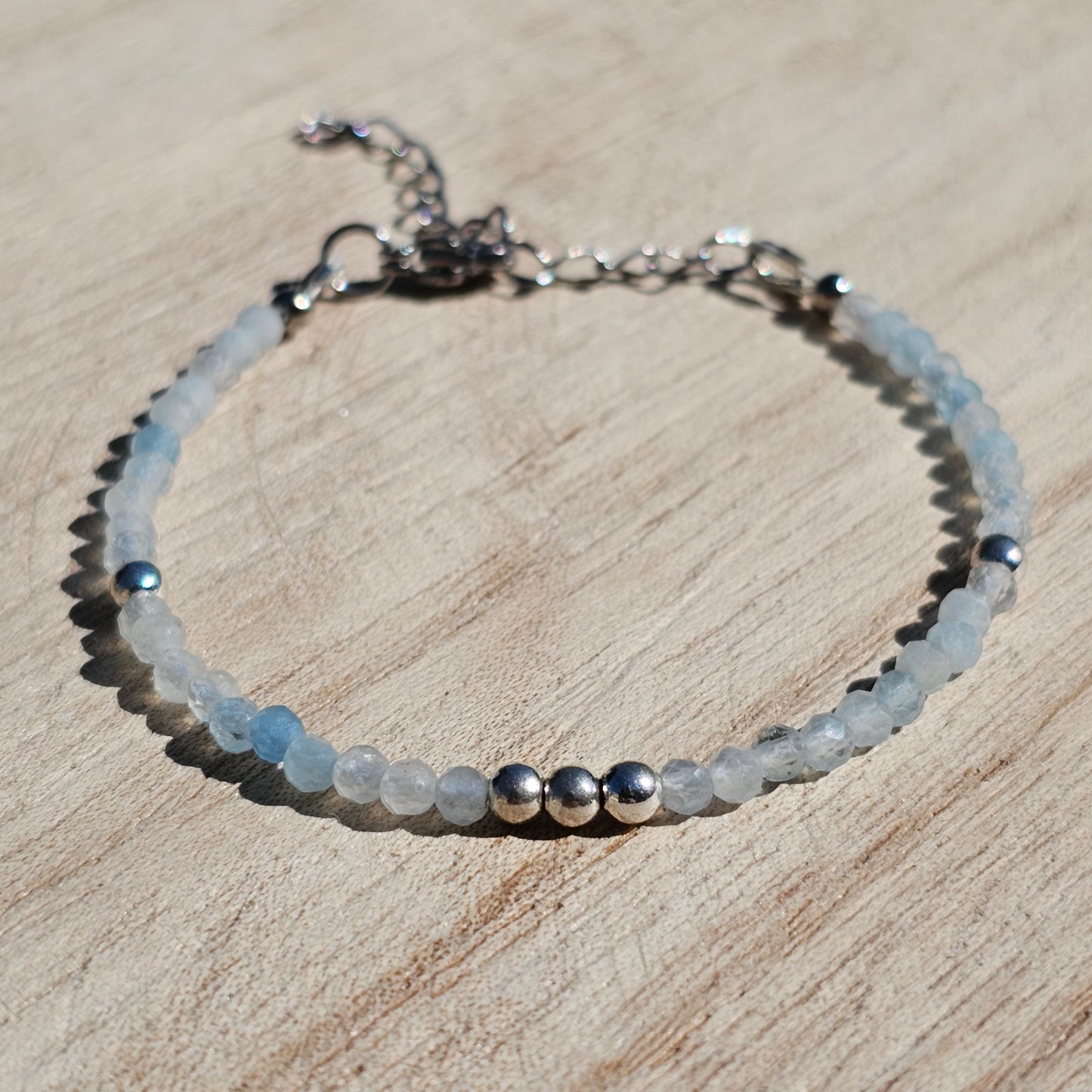 Delicate, faceted dainty Aquamarine and AAA grade silver plated Hematite bead bracelet with a silver stainless steel clasp and extender chain.