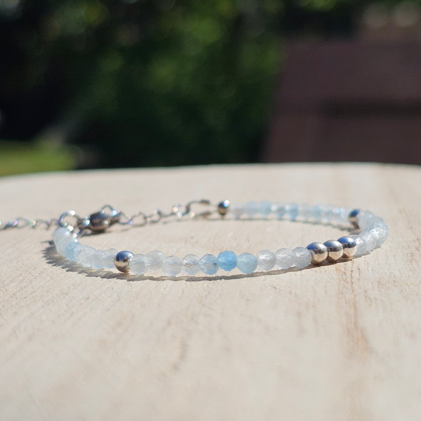 Delicate, faceted dainty Aquamarine and AAA grade silver plated Hematite bead bracelet with a silver stainless steel clasp and extender chain.