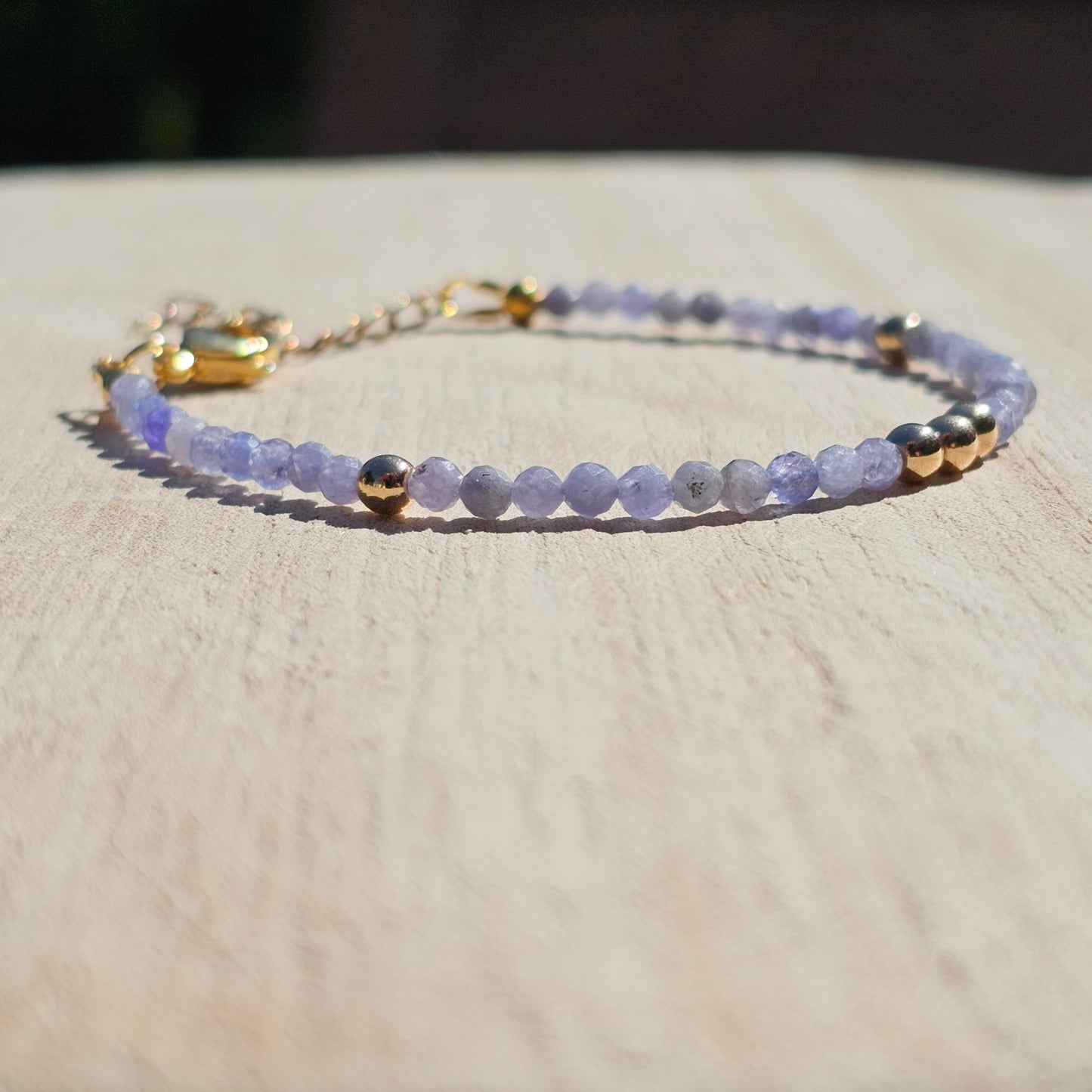 Delicate, faceted dainty Tanzanite and AAA grade gold plated Hematite bead bracelet with a gold stainless steel clasp and extender chain.