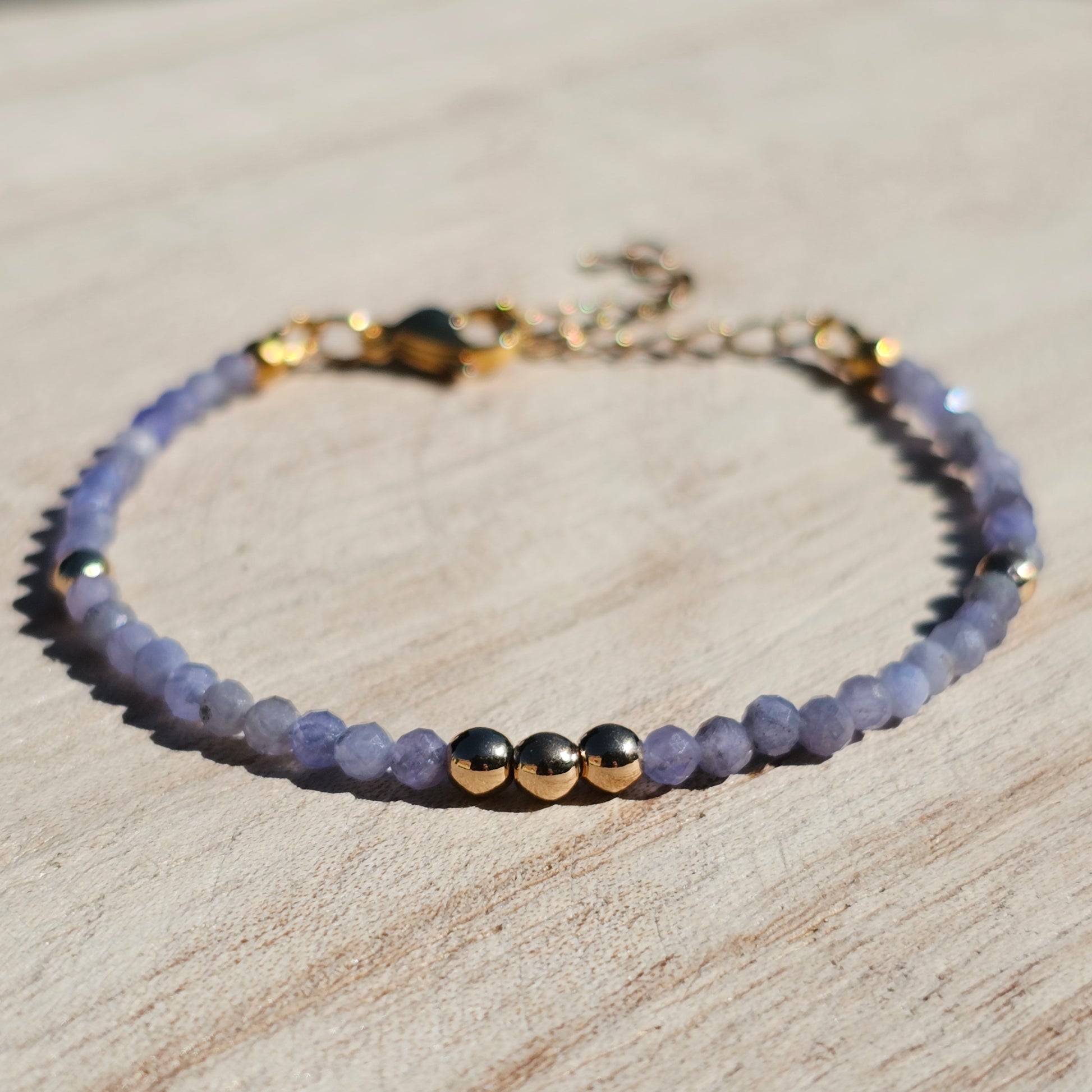 Delicate, faceted dainty Tanzanite and AAA grade gold plated Hematite bead bracelet with a gold stainless steel clasp and extender chain.