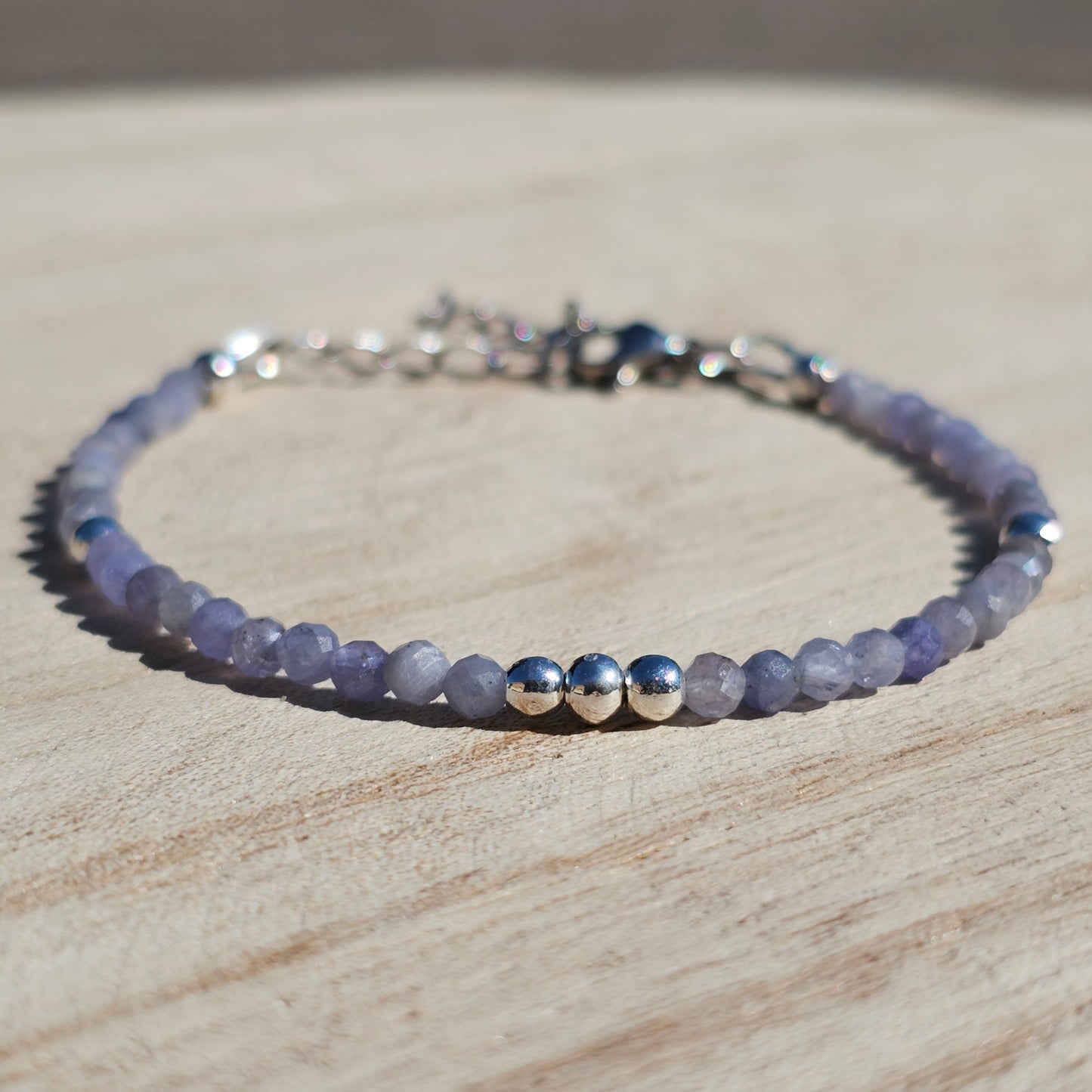 Delicate, faceted dainty Tanzanite and AAA grade silver plated Hematite bead bracelet with a silver stainless steel clasp and extender chain.