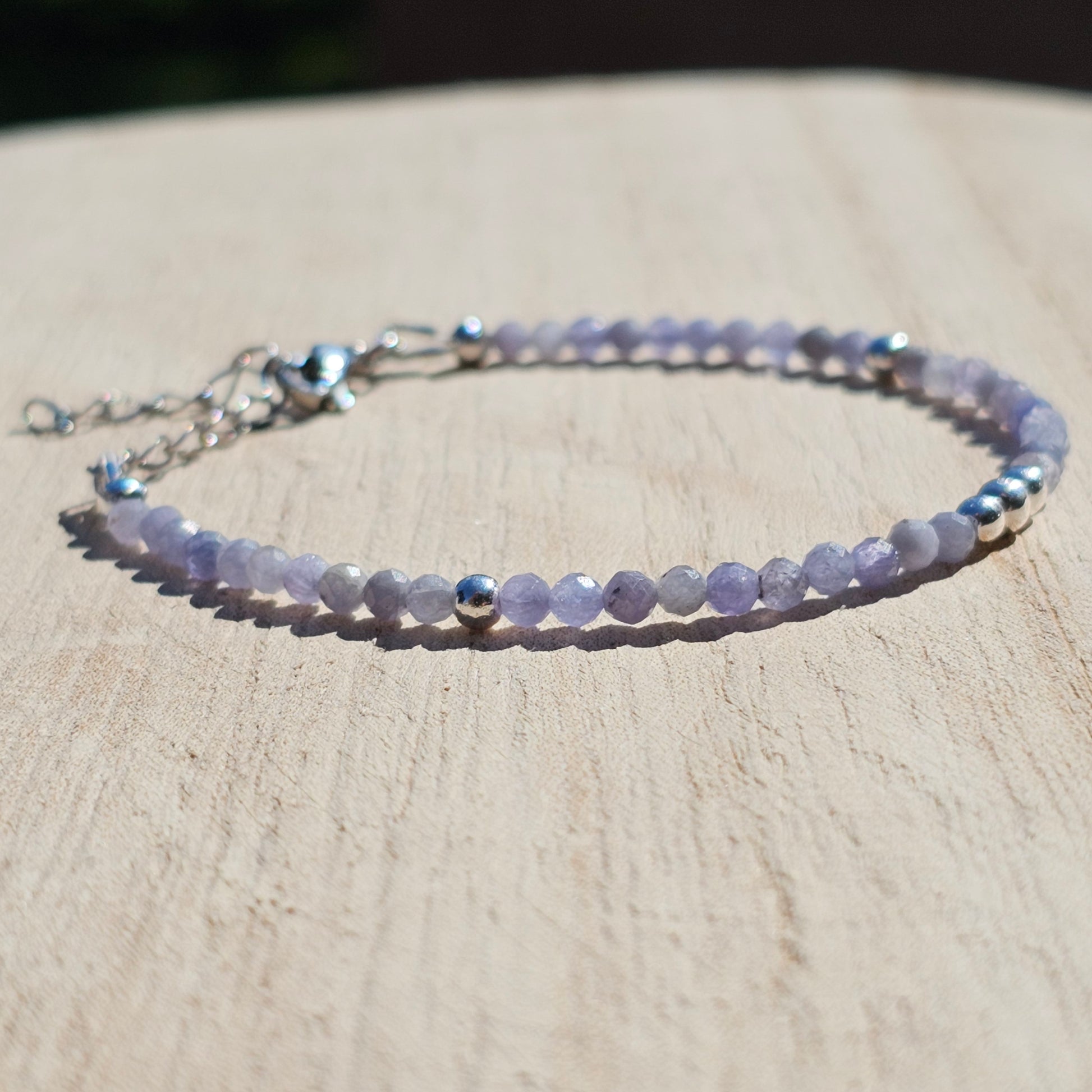 Delicate, faceted dainty Tanzanite and AAA grade silver plated Hematite bead bracelet with a silver stainless steel clasp and extender chain.