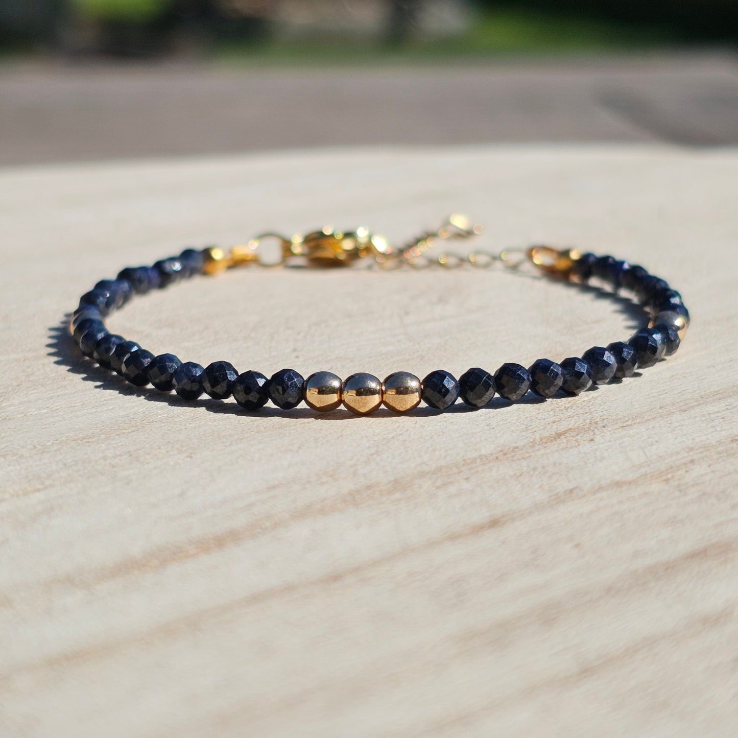 Delicate, faceted dainty A grade Sapphire and AAA grade gold plated Hematite bead bracelet with a gold stainless steel clasp and extender chain.