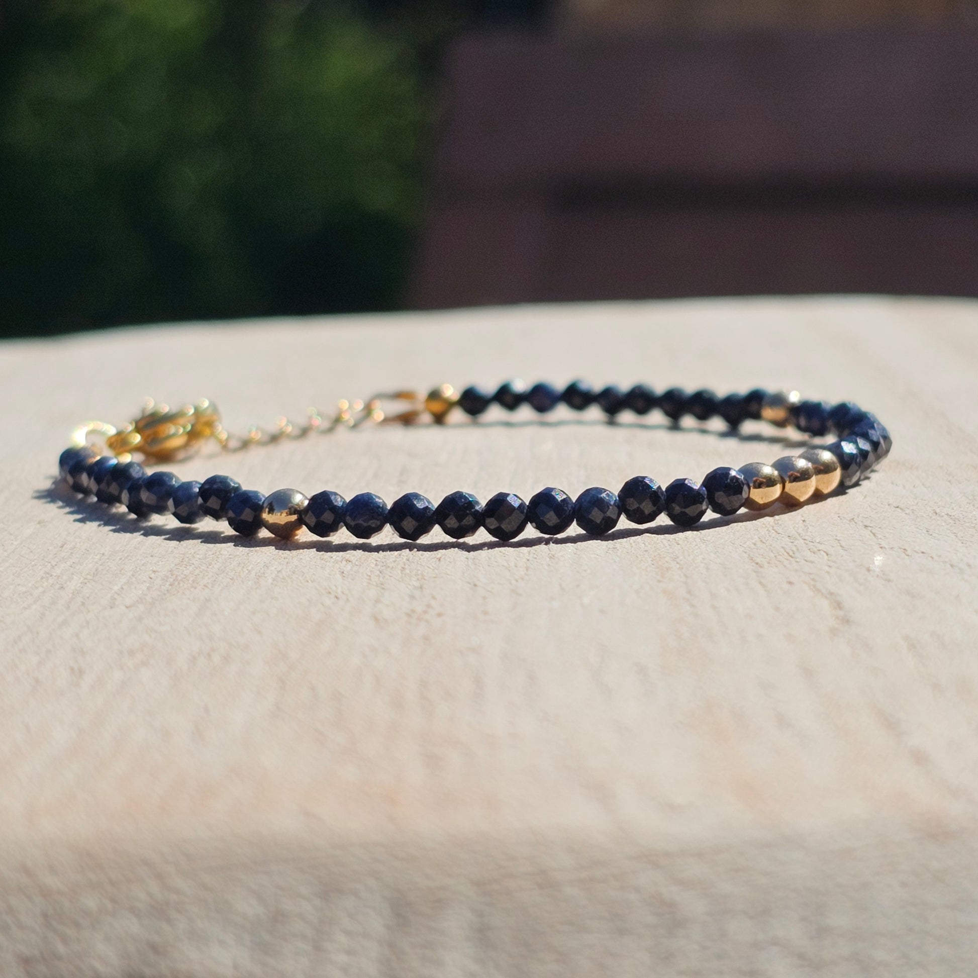 Delicate, faceted dainty A grade Sapphire and AAA grade gold plated Hematite bead bracelet with a gold stainless steel clasp and extender chain.