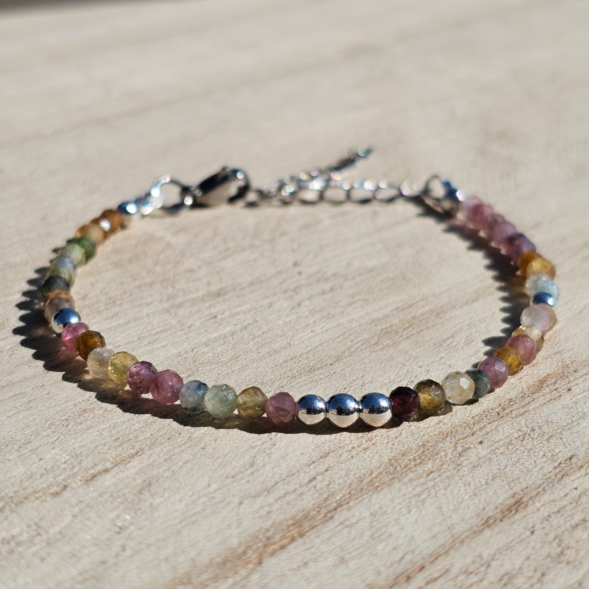 Delicate, faceted dainty AA grade colourful Tourmaline and AAA grade silver plated Hematite bead bracelet with a silver stainless steel clasp and extender chain.