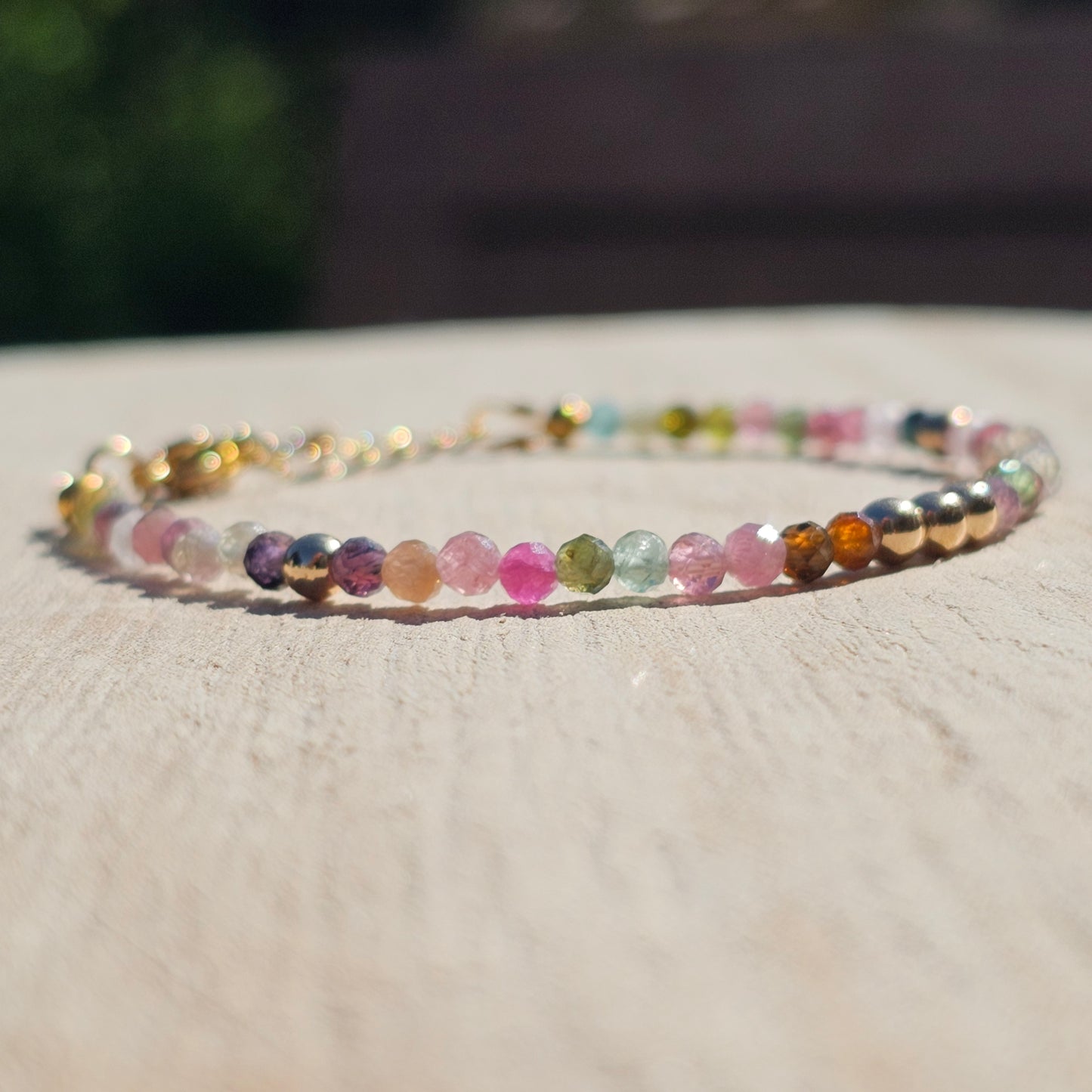 Delicate, faceted dainty AA grade colourful Tourmaline and AAA grade gold plated Hematite bead bracelet with a gold stainless steel clasp and extender chain.