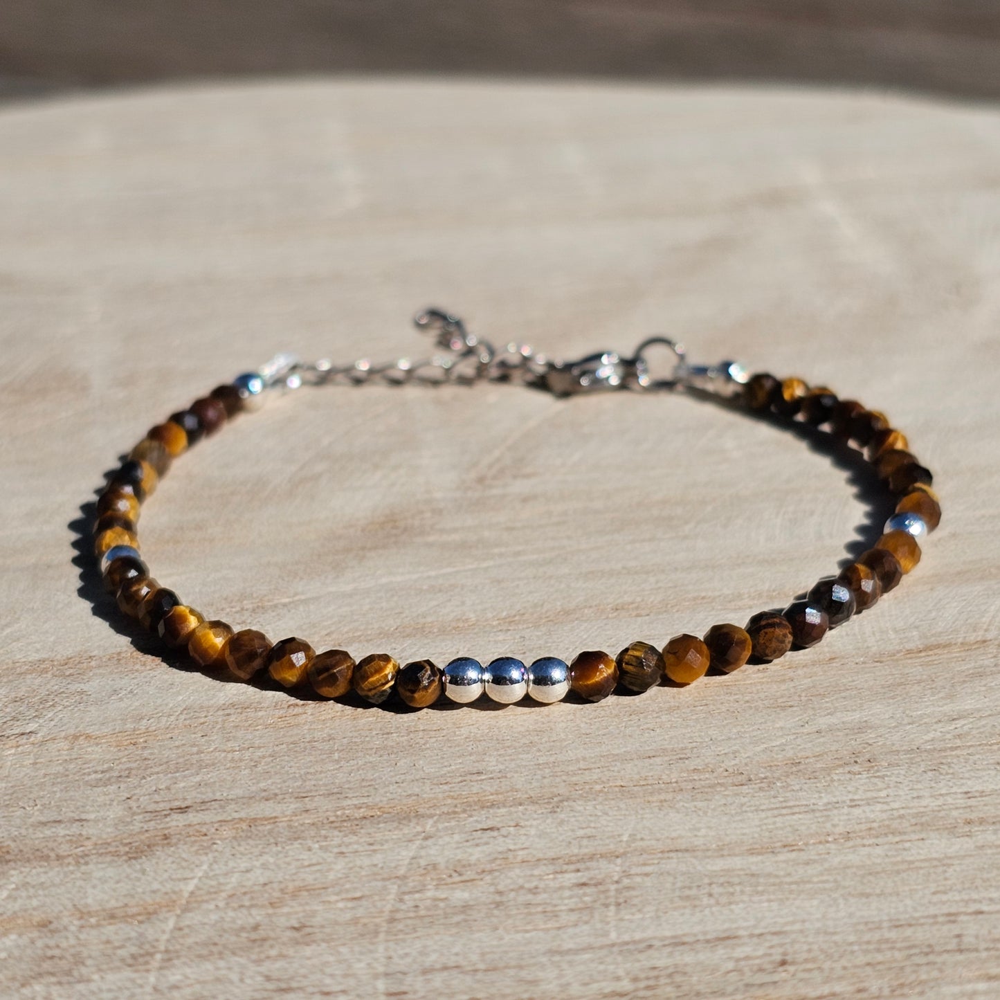 Delicate, faceted dainty Tiger's Eye and AAA grade silver plated Hematite bead bracelet with a silver stainless steel clasp and extender chain.