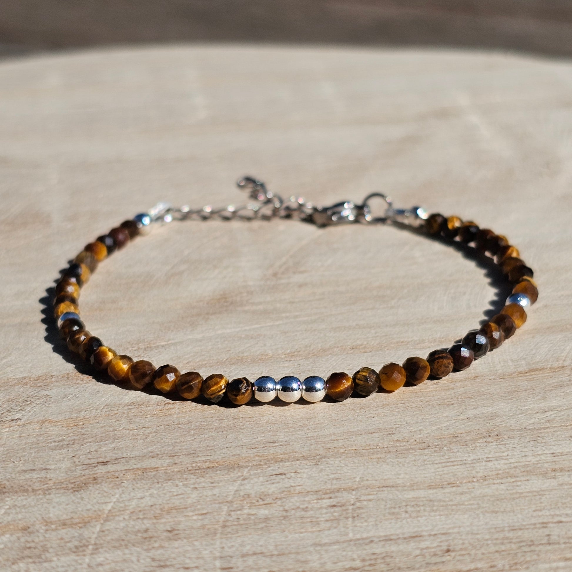 Delicate, faceted dainty Tiger's Eye and AAA grade silver plated Hematite bead bracelet with a silver stainless steel clasp and extender chain.