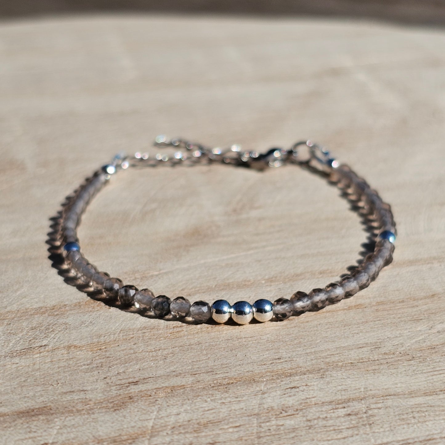 Delicate, faceted dainty Smoky Quartz and AAA grade silver plated Hematite bead bracelet with a silver stainless steel clasp and extender chain.