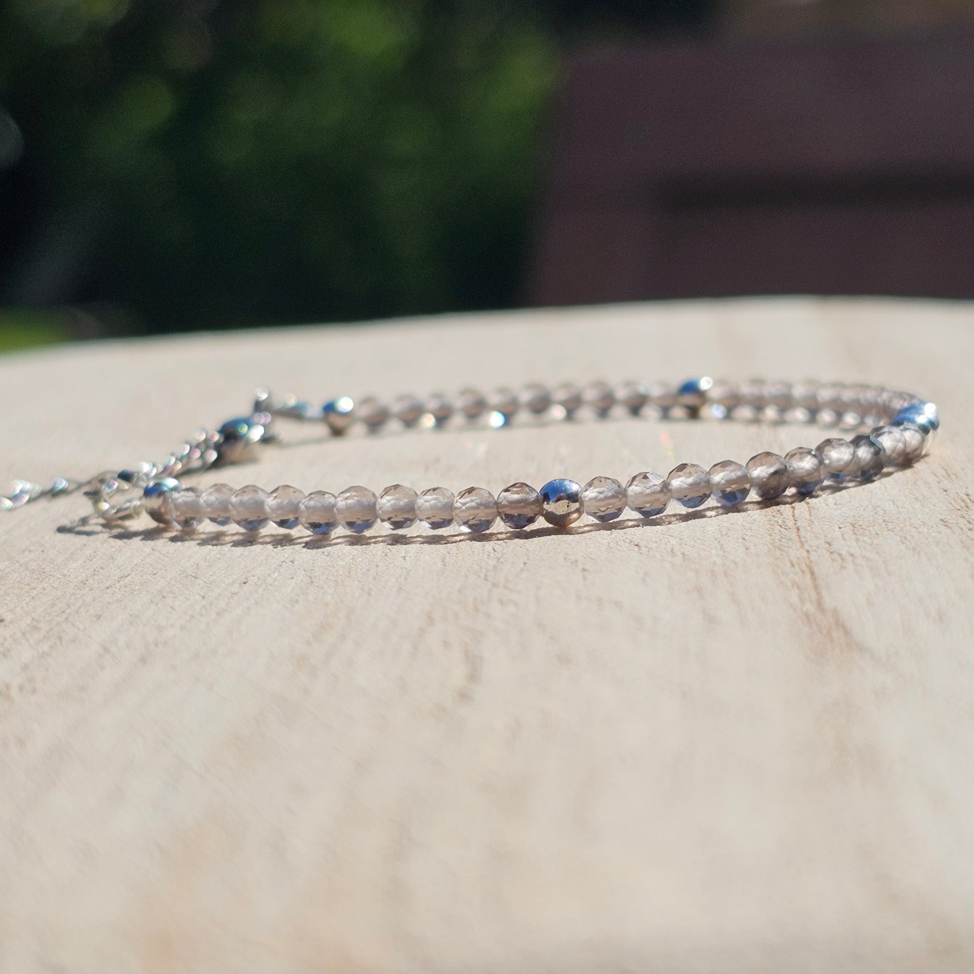 Delicate, faceted dainty Smoky Quartz and AAA grade silver plated Hematite bead bracelet with a silver stainless steel clasp and extender chain.