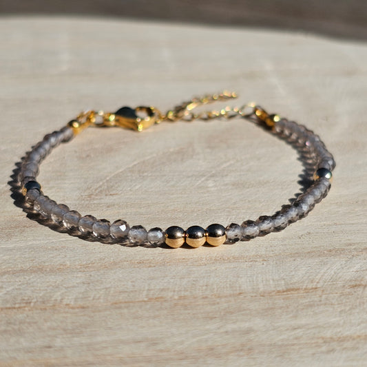 Delicate, faceted dainty Smoky Quartz and AAA grade gold plated Hematite bead bracelet with a gold stainless steel clasp and extender chain.