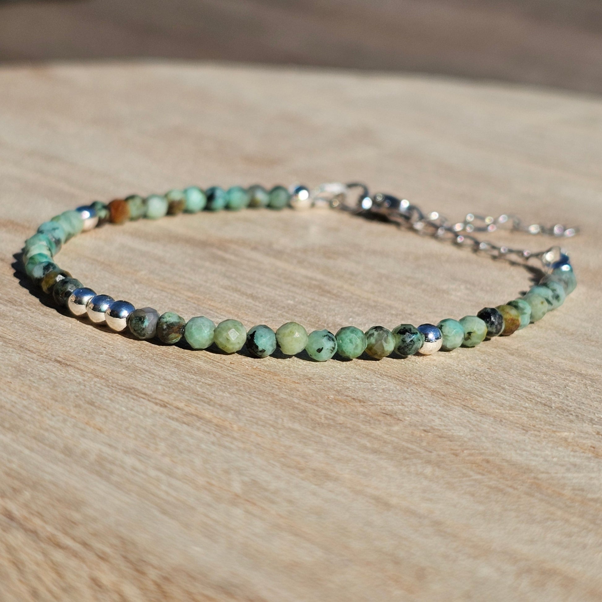 Delicate, faceted dainty African Turquoise and AAA grade silver plated Hematite bead bracelet with a silver stainless steel clasp and extender chain.