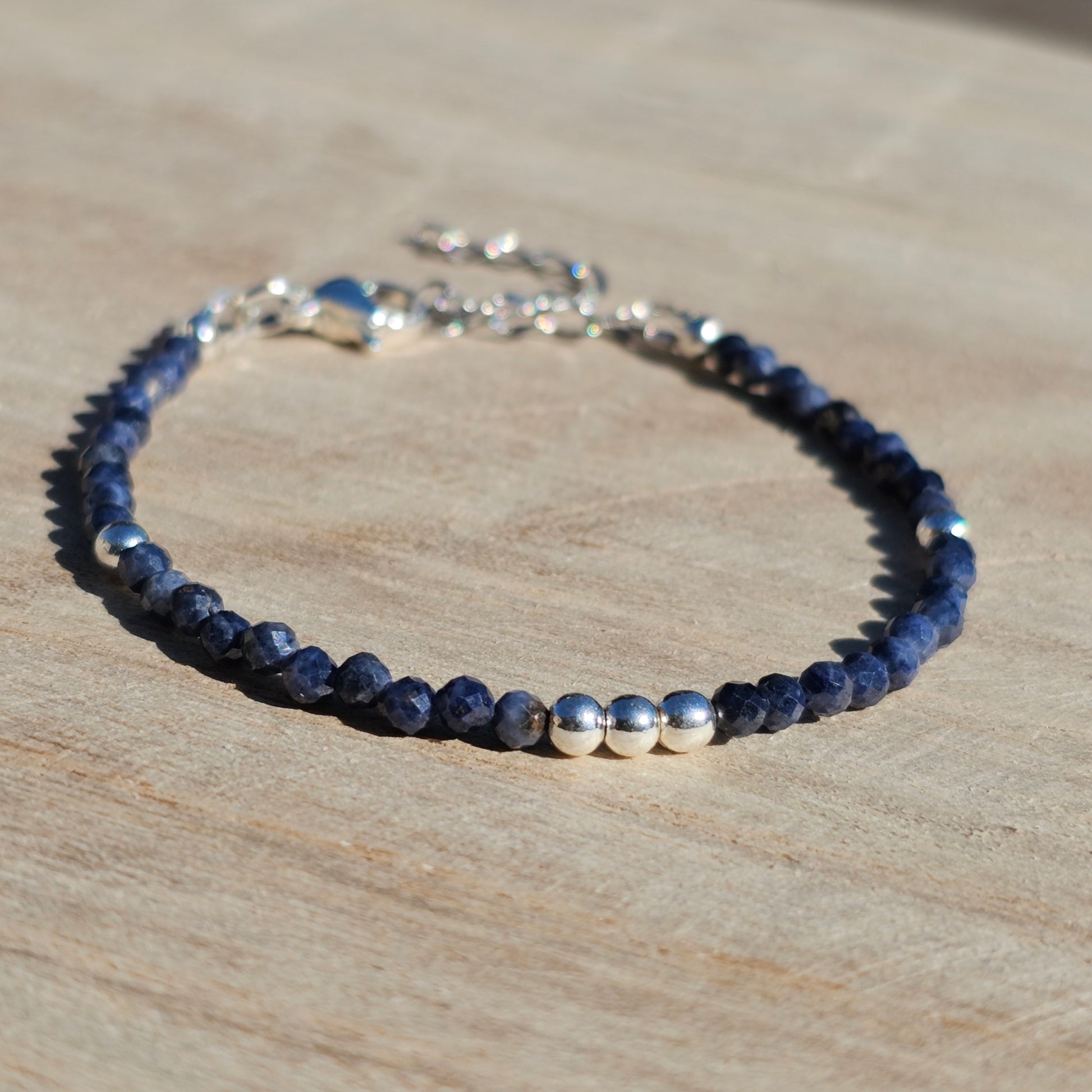 Delicate, faceted dainty A grade Sapphire and AAA grade silver plated Hematite bead bracelet with a silver stainless steel clasp and extender chain.