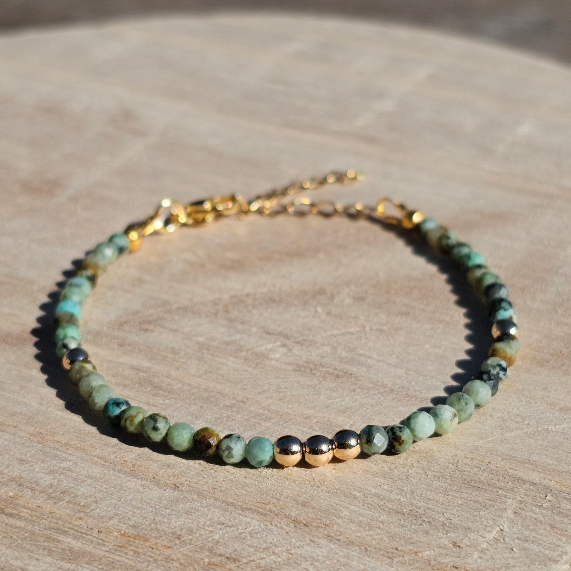 Delicate, faceted dainty African Turquoise and AAA grade gold plated Hematite bead bracelet with a gold stainless steel clasp and extender chain.