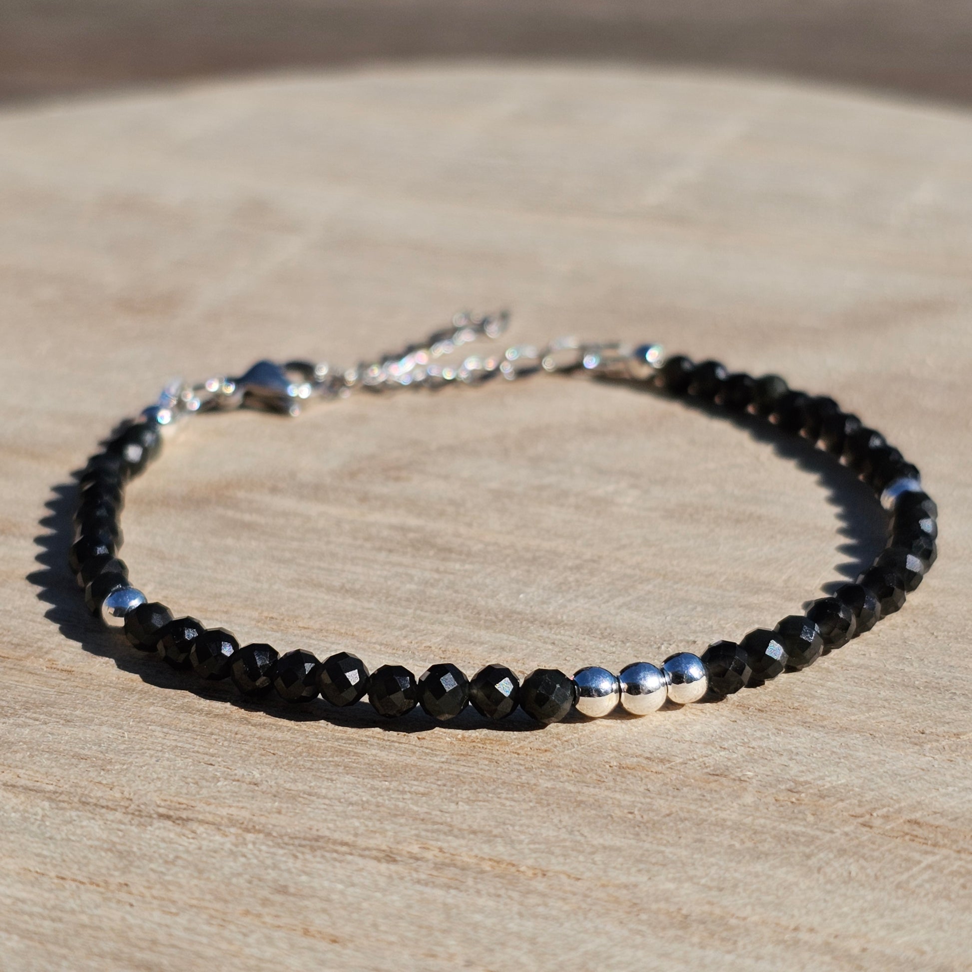 Delicate, faceted dainty Obsidian and AAA grade silver plated Hematite bead bracelet with a silver stainless steel clasp and extender chain.