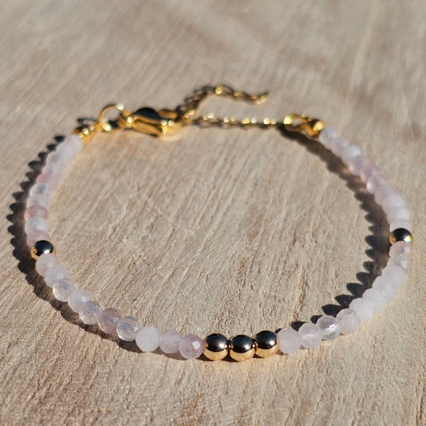 Delicate, faceted dainty Rose Quartz and AAA grade gold plated Hematite bead bracelet with a gold stainless steel clasp and extender chain.