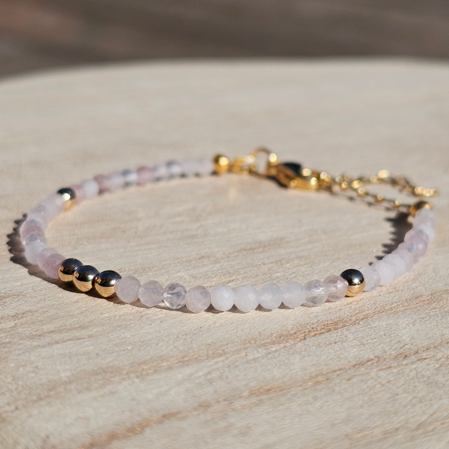 Delicate, faceted dainty Rose Quartz and AAA grade gold plated Hematite bead bracelet with a gold stainless steel clasp and extender chain.