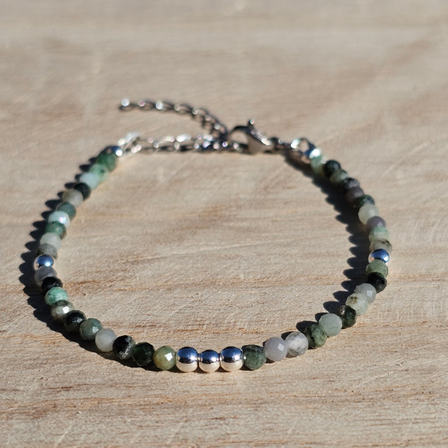 Delicate, faceted dainty Emerald and AAA grade silver plated Hematite bead bracelet with a silver stainless steel clasp and extender chain.