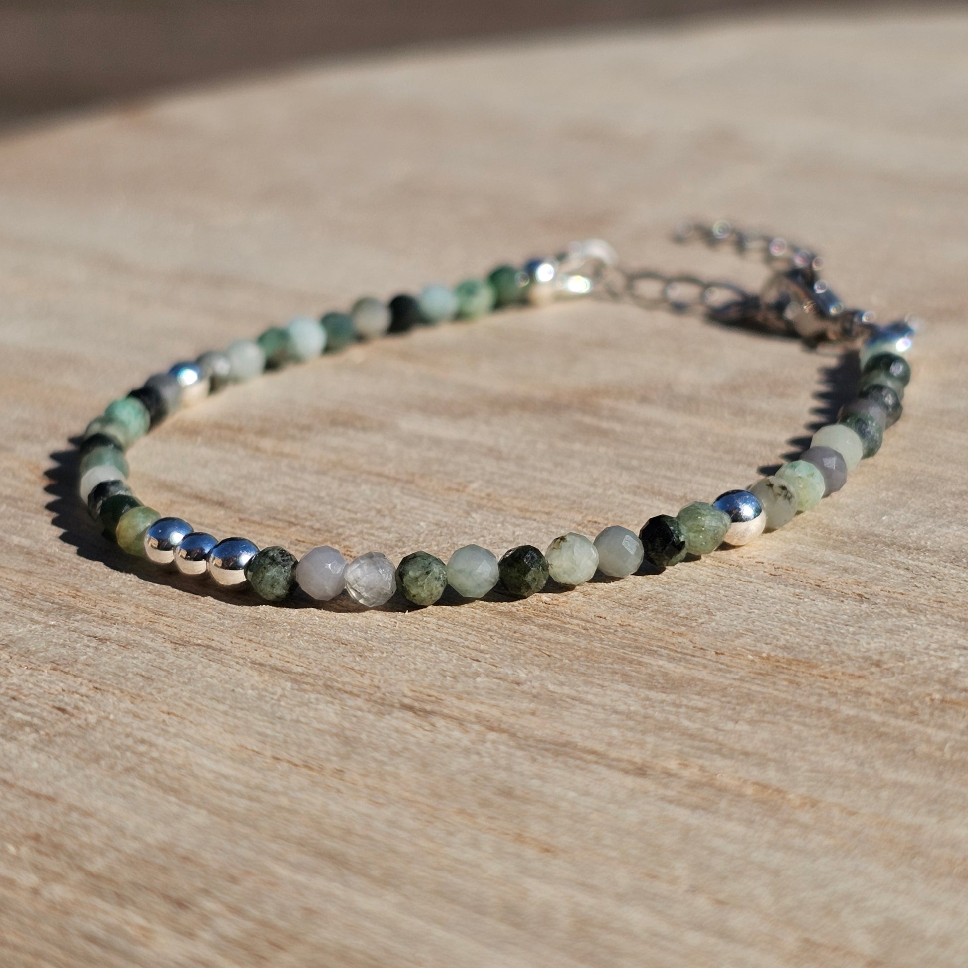 Delicate, faceted dainty Emerald and AAA grade silver plated Hematite bead bracelet with a silver stainless steel clasp and extender chain.