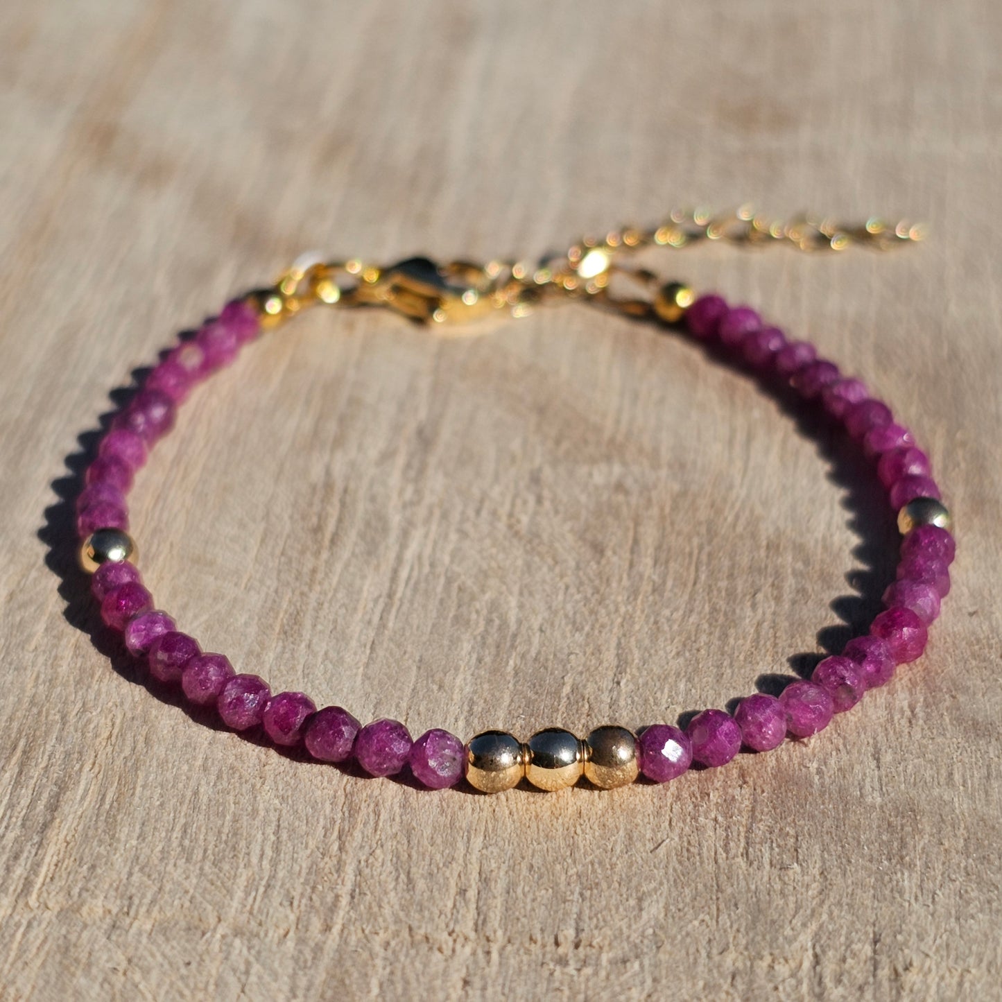 Delicate, faceted dainty Ruby and AAA grade gold plated Hematite bead bracelet with a gold stainless steel clasp and extender chain.