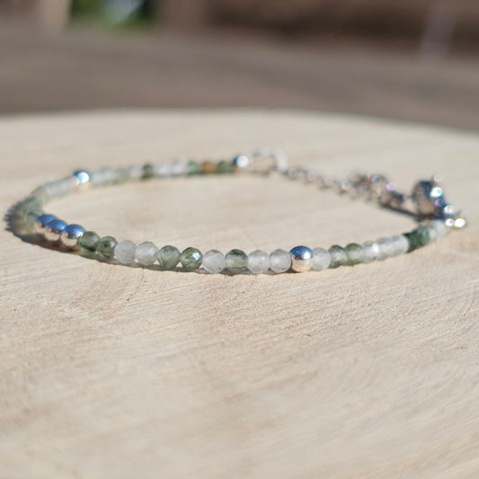 Delicate, faceted dainty green Rutile Quartz and AAA grade silver plated Hematite bead bracelet with a silver stainless steel clasp and extender chain.