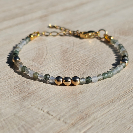 Delicate, faceted dainty green Rutile Quartz and AAA grade gold plated Hematite bead bracelet with a gold stainless steel clasp and extender chain.