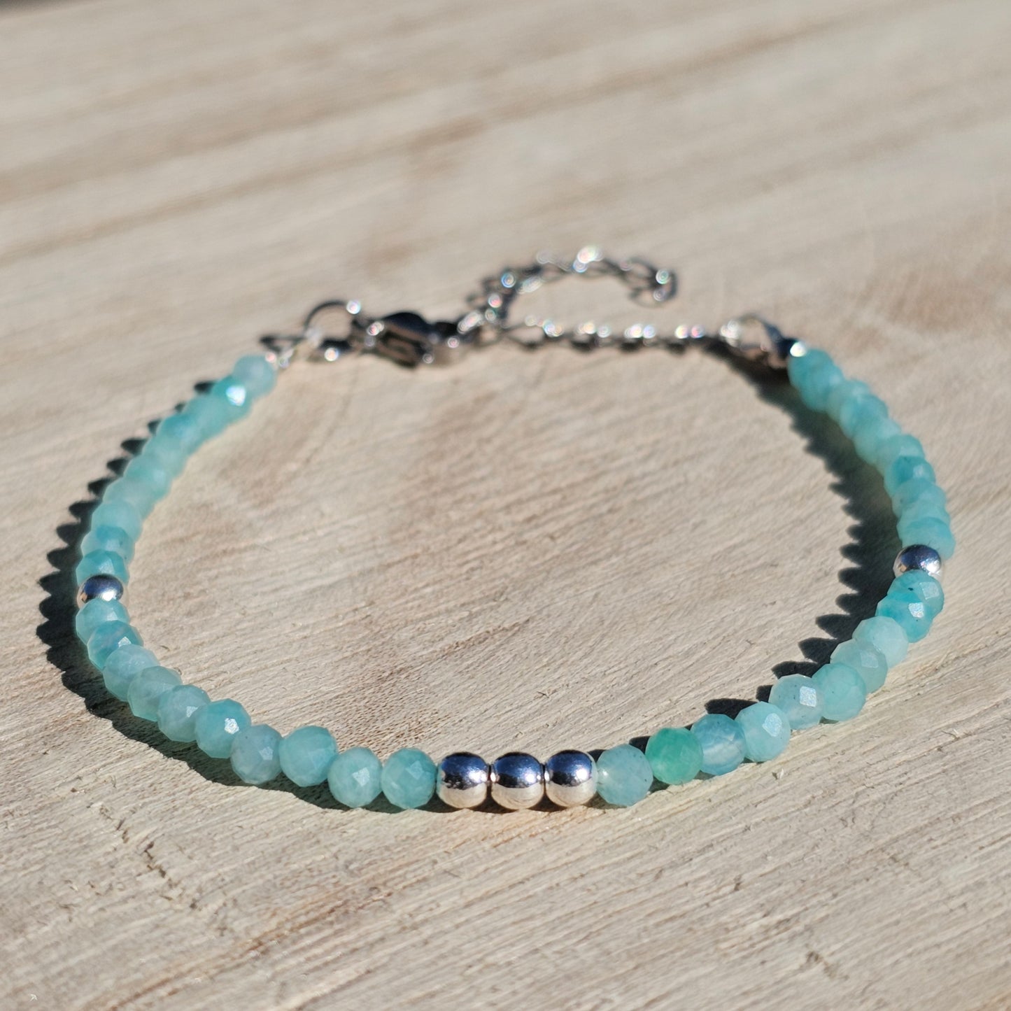 Delicate, faceted dainty A grade Amazonite and AAA grade silver plated Hematite bead bracelet with a silver stainless steel clasp and extender chain.