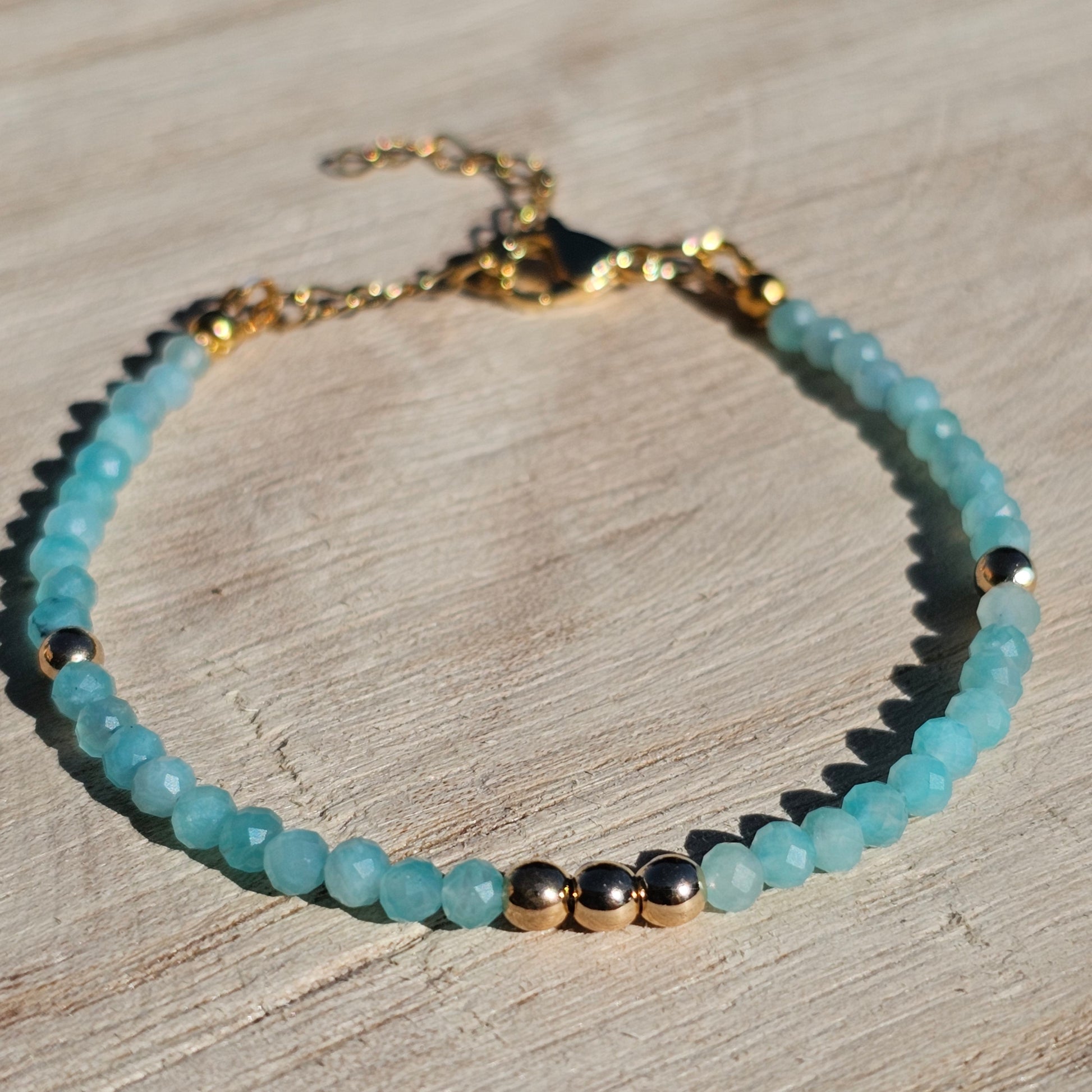 Delicate, faceted dainty A grade Amazonite and AAA grade gold plated Hematite bead bracelet with a gold stainless steel clasp and extender chain.