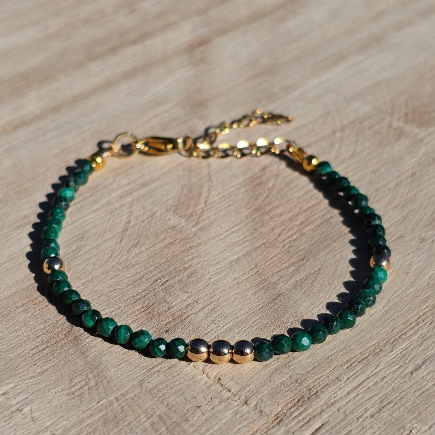 Delicate, faceted dainty Malachite and AAA grade gold plated Hematite bead bracelet with a gold stainless steel clasp and extender chain.