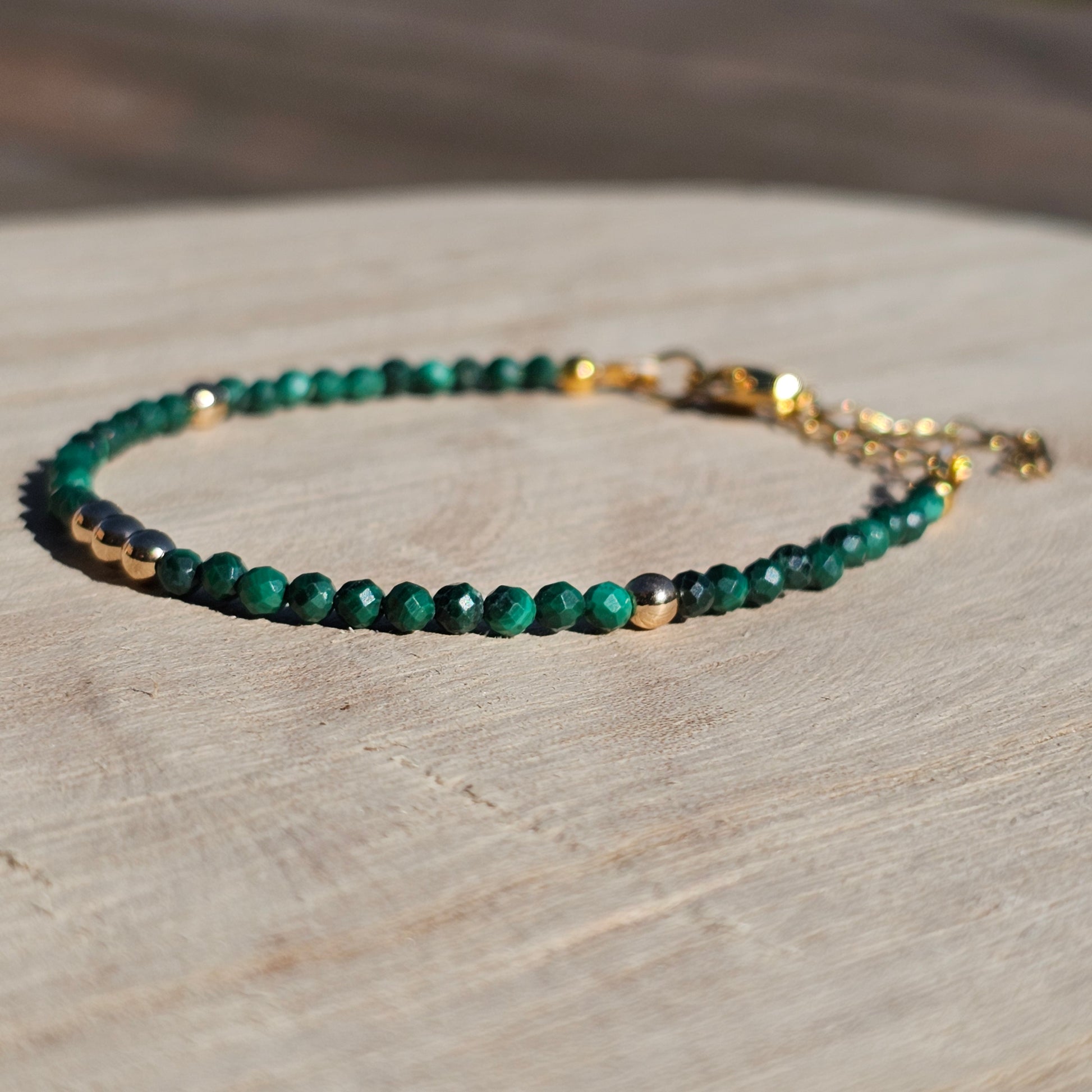 Delicate, faceted dainty Malachite and AAA grade gold plated Hematite bead bracelet with a gold stainless steel clasp and extender chain.