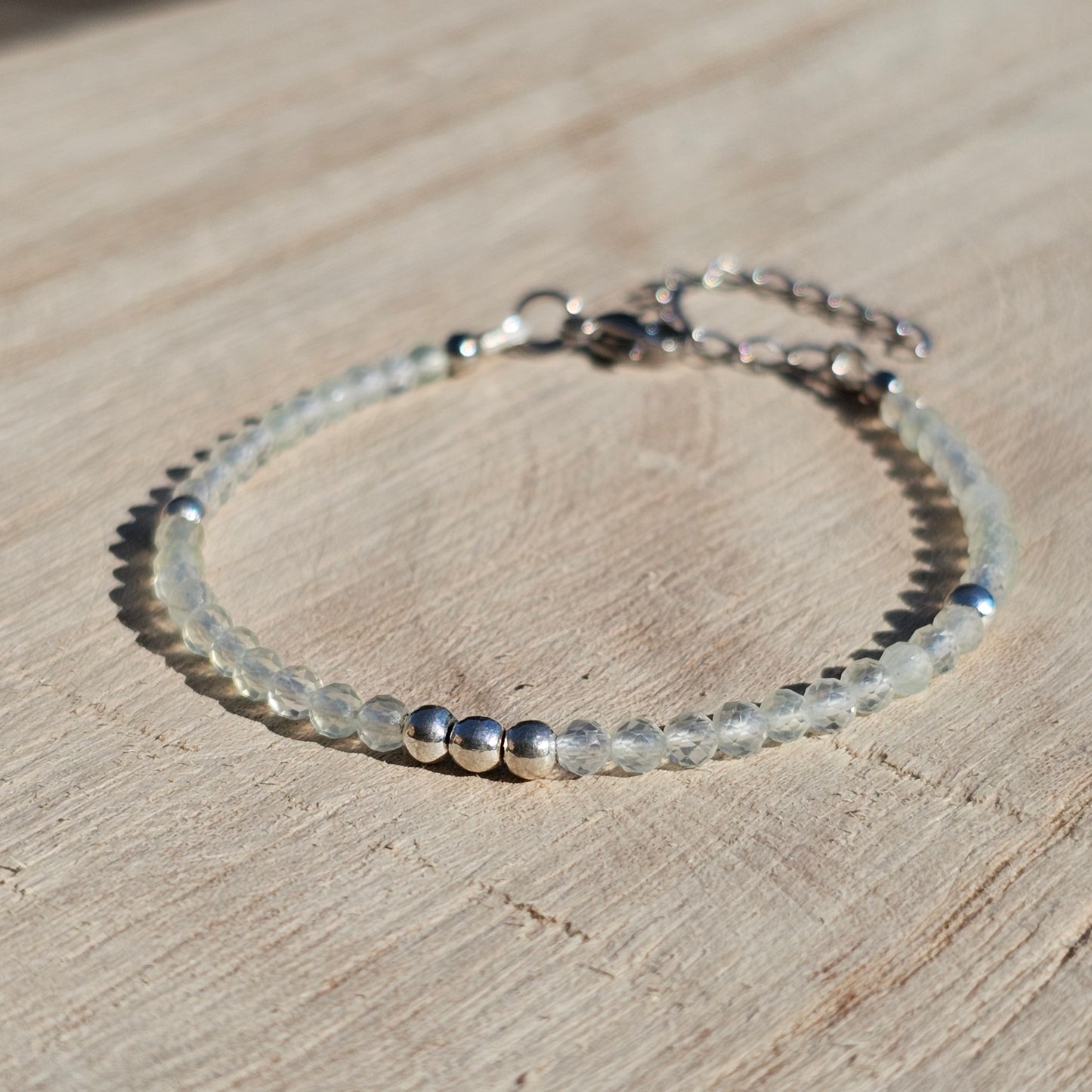 Delicate, faceted dainty Prehnite and AAA grade silver plated Hematite bead bracelet with a silver stainless steel clasp and extender chain.