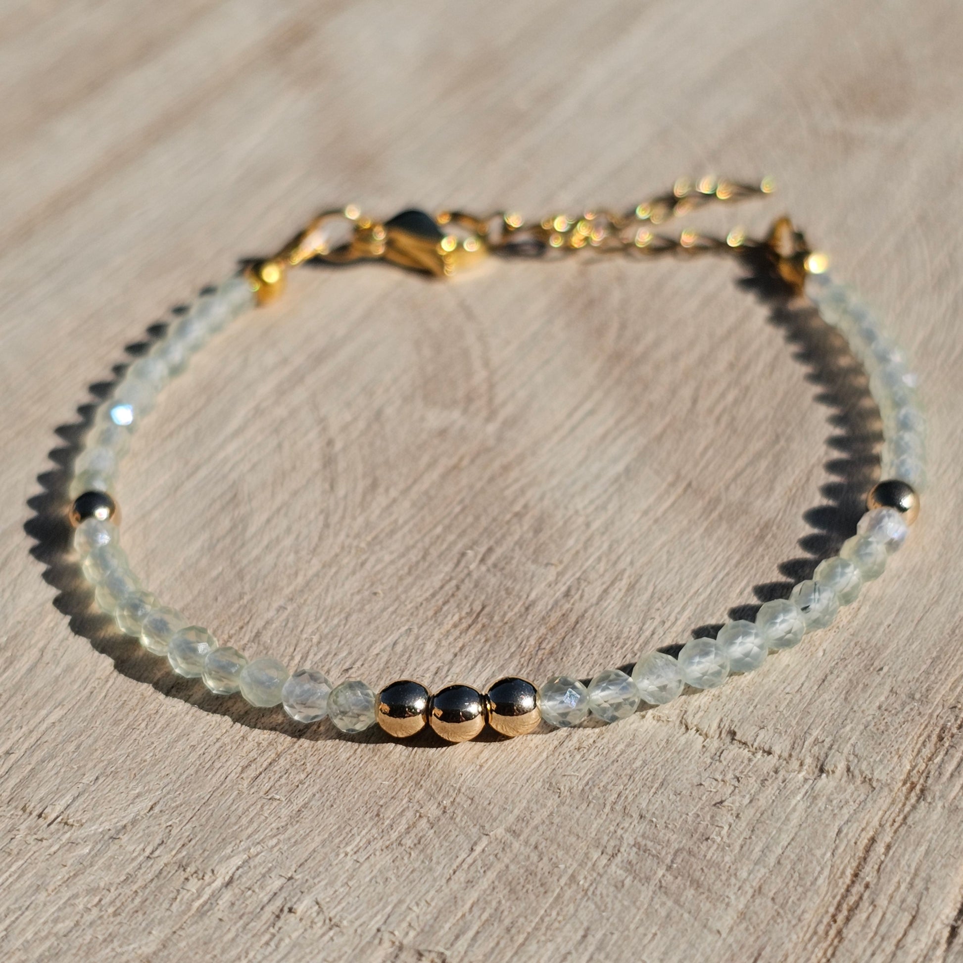 Delicate, faceted dainty Prehnite and AAA grade gold plated Hematite bead bracelet with a gold stainless steel clasp and extender chain.