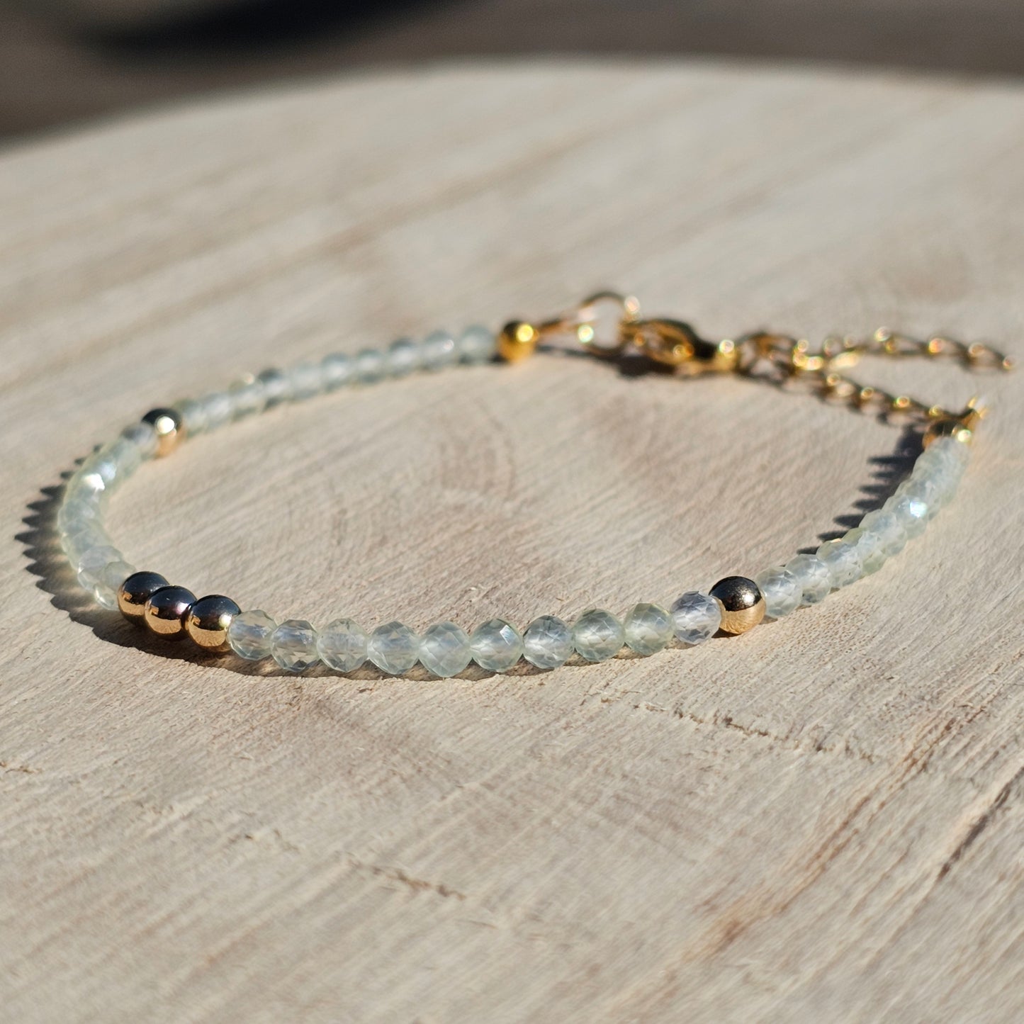 Delicate, faceted dainty Prehnite and AAA grade gold plated Hematite bead bracelet with a gold stainless steel clasp and extender chain.