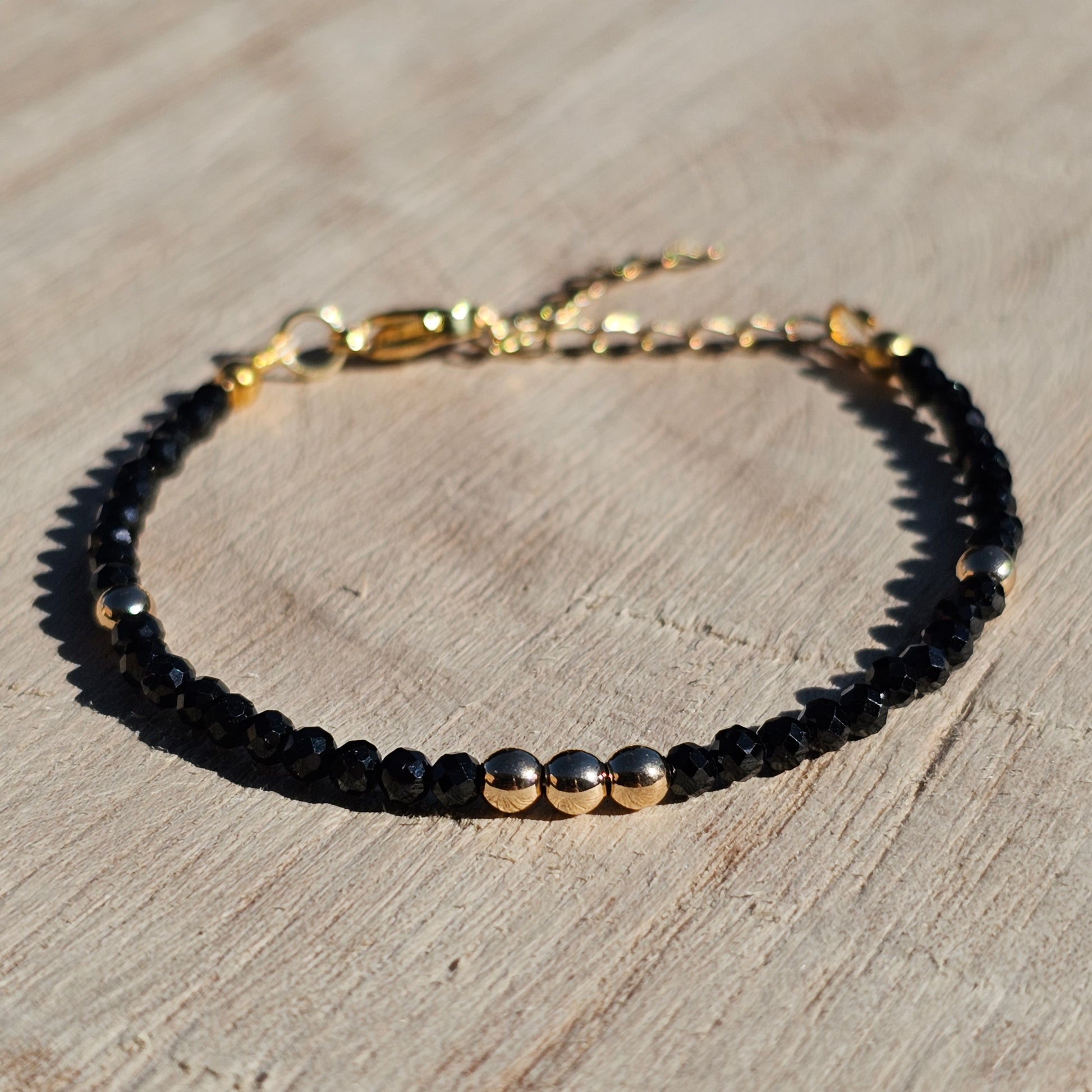 Delicate, faceted dainty Spinel and AAA grade gold plated Hematite bead bracelet with a gold stainless steel clasp and extender chain.