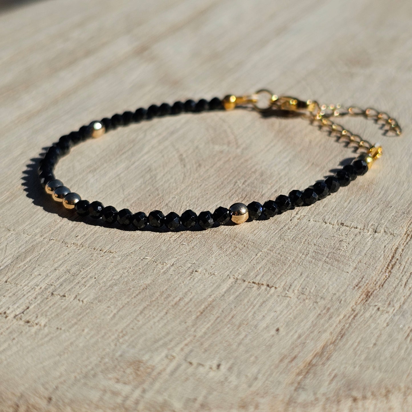 Delicate, faceted dainty Spinel and AAA grade gold plated Hematite bead bracelet with a gold stainless steel clasp and extender chain.