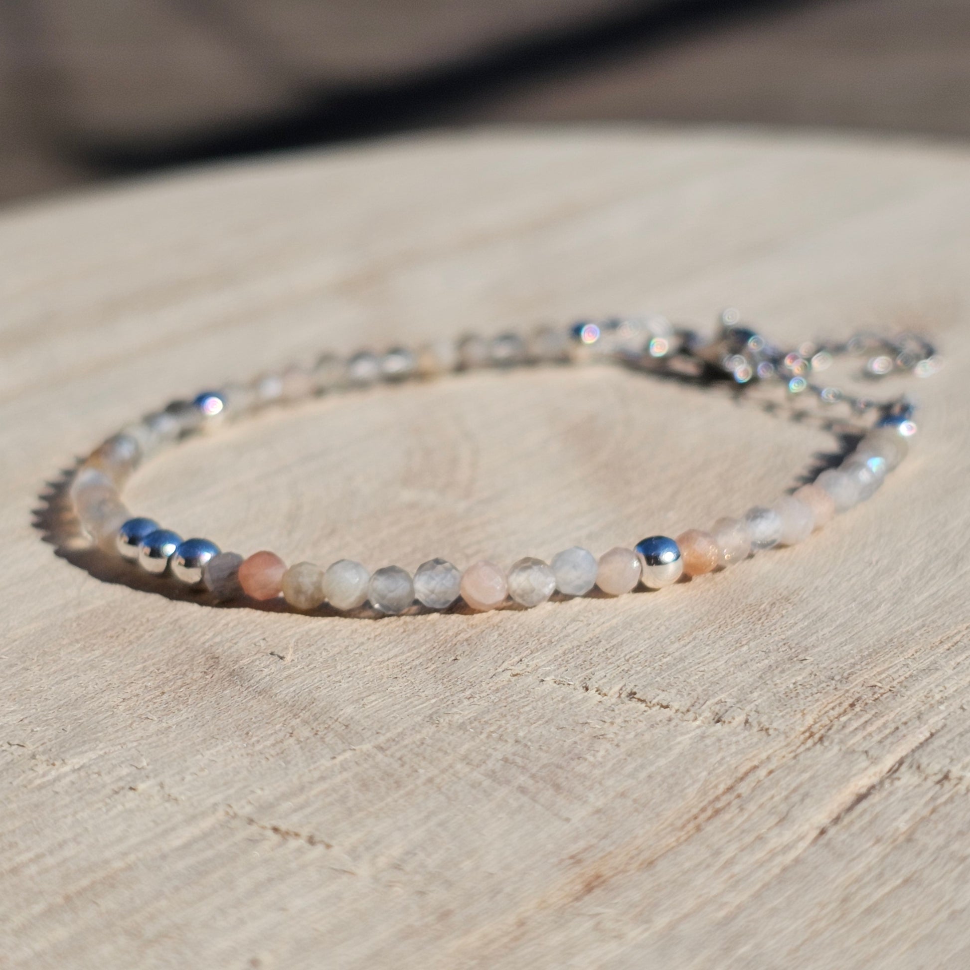 Delicate, faceted dainty Moonstone and AAA grade silver plated Hematite bead bracelet with a silver stainless steel clasp and extender chain.