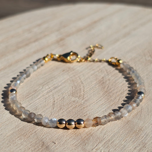 Delicate, faceted dainty Moonstone and AAA grade gold plated Hematite bead bracelet with a gold stainless steel clasp and extender chain.