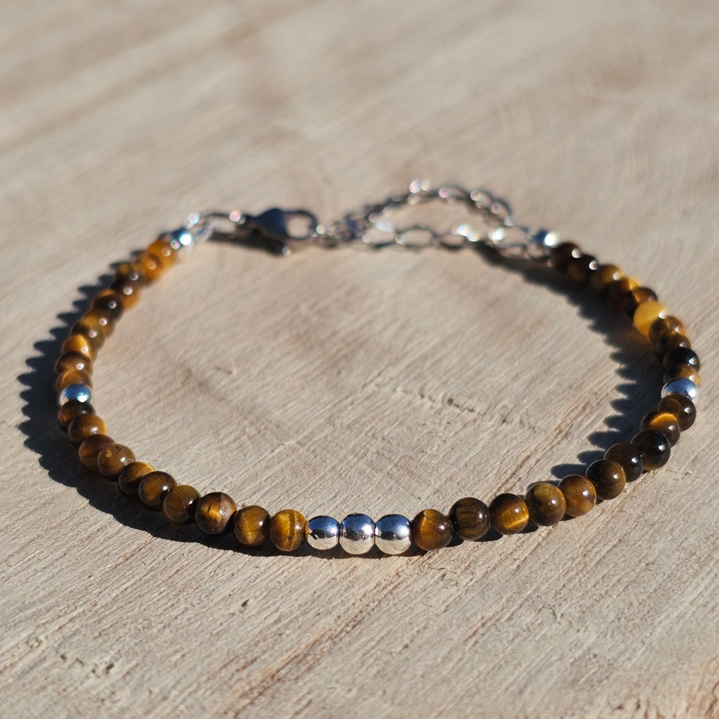 Delicate, round dainty AA Grade Tigers Eye and AAA grade silver plated Hematite bead bracelet with a silver stainless steel clasp and extender chain.