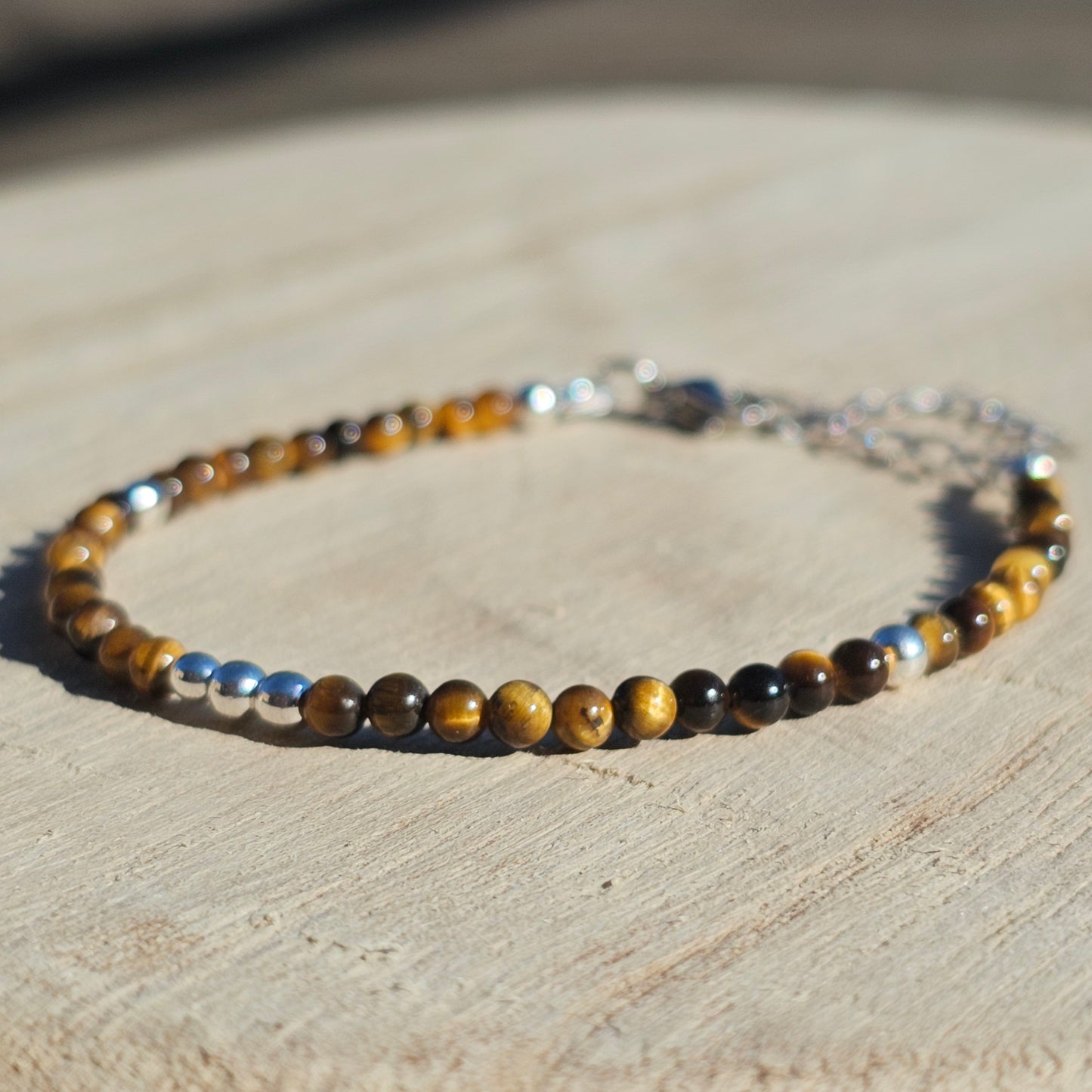 Delicate, round dainty AA Grade Tigers Eye and AAA grade silver plated Hematite bead bracelet with a silver stainless steel clasp and extender chain.