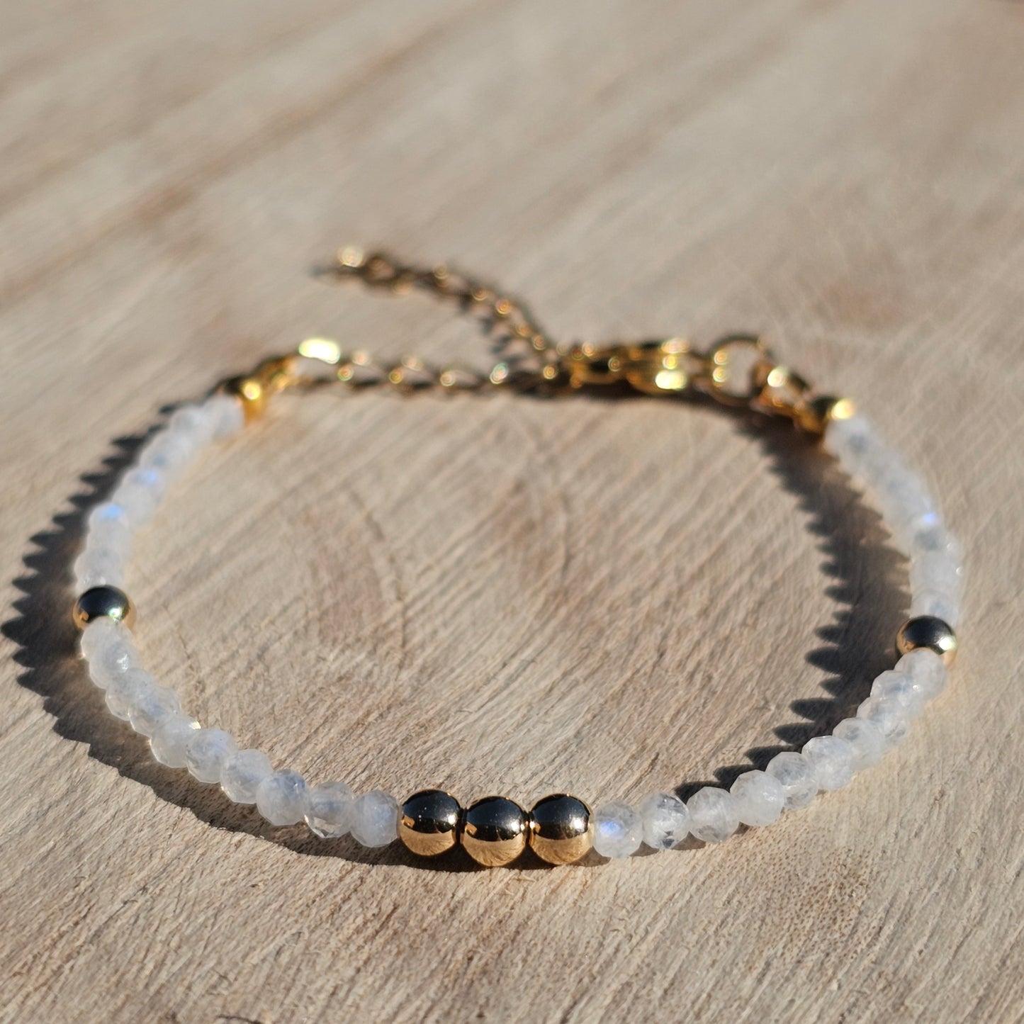 Delicate, faceted dainty AAA grade Rainbow Moonstone and AAA grade gold plated Hematite bead bracelet with a gold stainless steel clasp and extender chain.