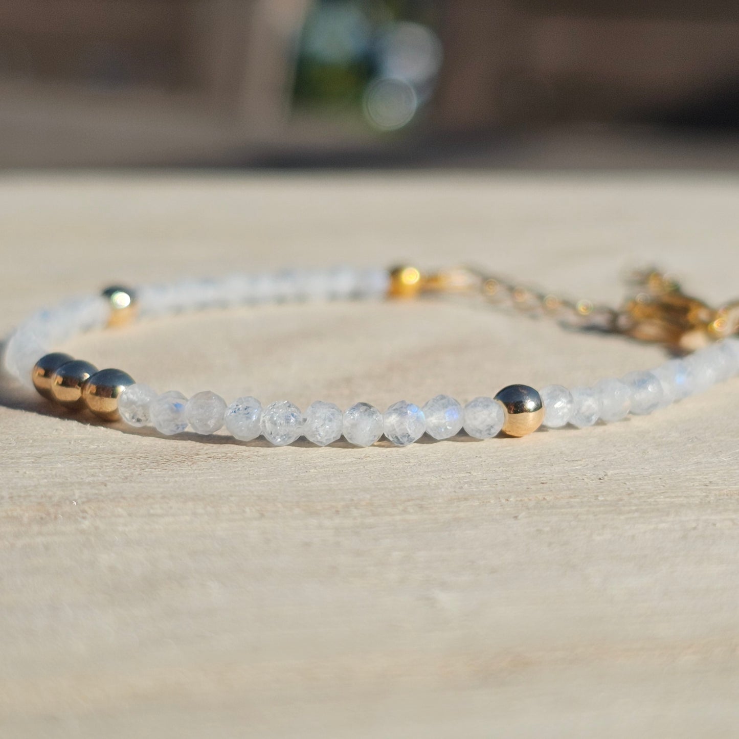 Delicate, faceted dainty AAA grade Rainbow Moonstone and AAA grade gold plated Hematite bead bracelet with a gold stainless steel clasp and extender chain.