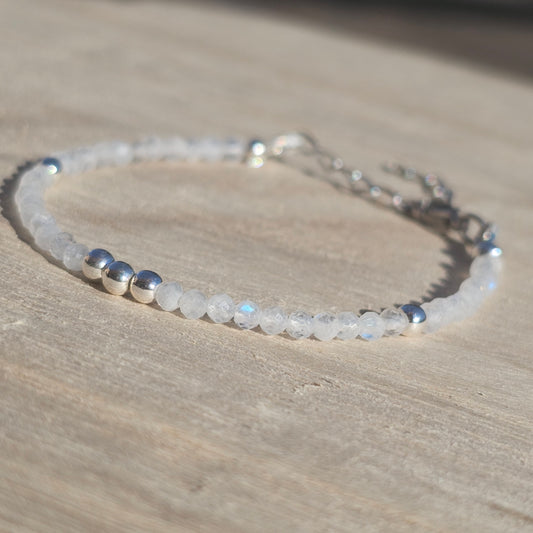 Delicate, faceted dainty AAA grade Rainbow Moonstone and AAA grade silver plated Hematite bead bracelet with a silver stainless steel clasp and extender chain.