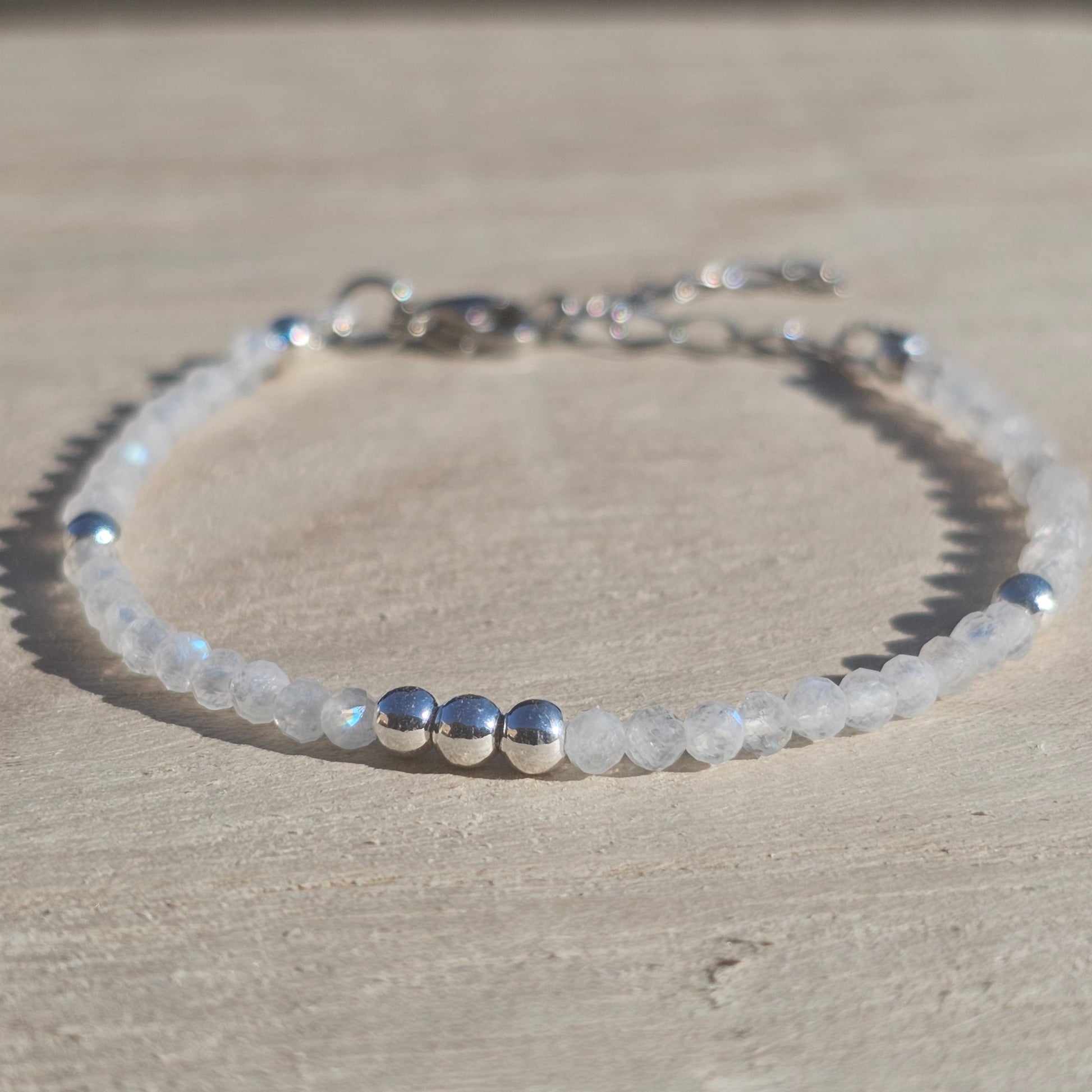 Delicate, faceted dainty AAA grade Rainbow Moonstone and AAA grade silver plated Hematite bead bracelet with a silver stainless steel clasp and extender chain.