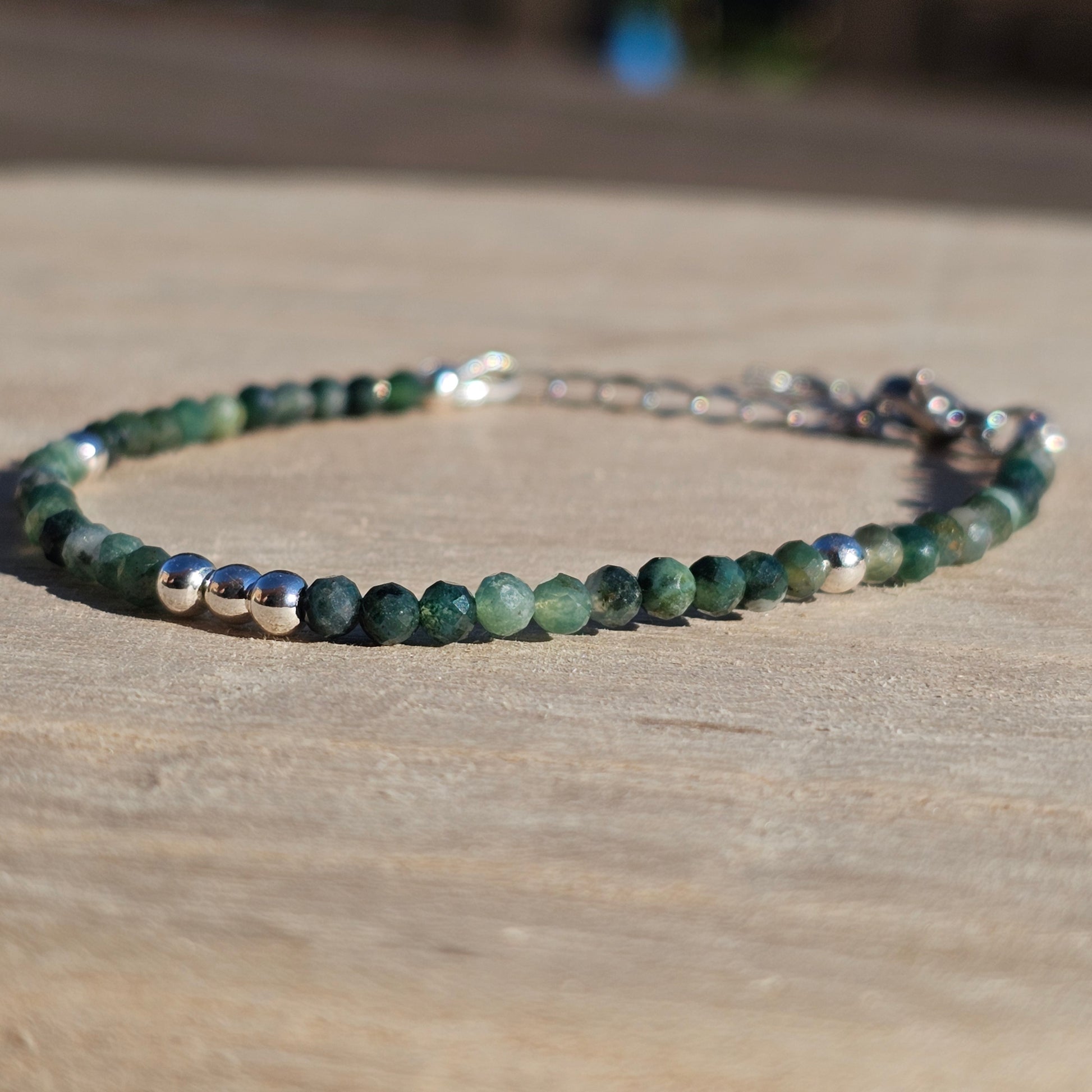 Delicate, faceted dainty Moss Agate and AAA grade silver plated Hematite bead bracelet with a silver stainless steel clasp and extender chain.