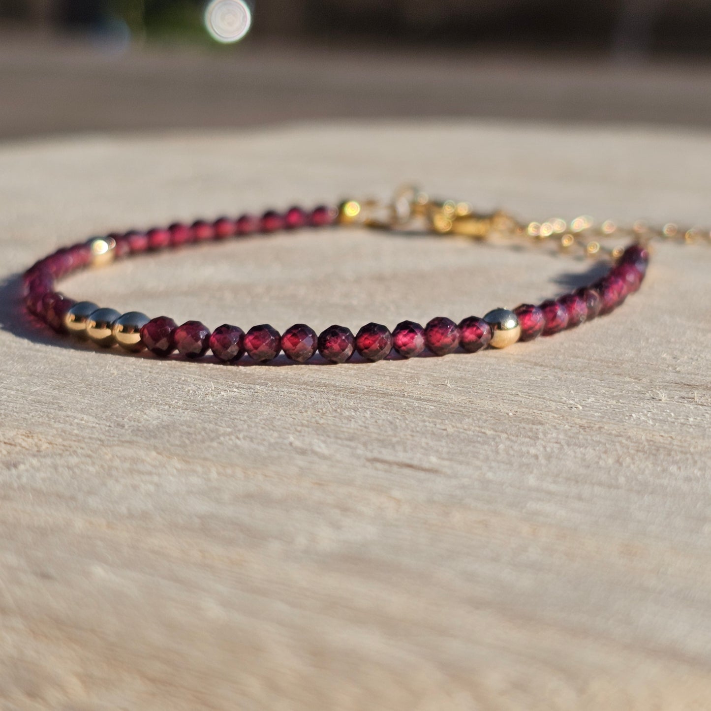 Delicate, faceted dainty AA grade Garnet and AAA grade gold plated Hematite bead bracelet with a gold stainless steel clasp and extender chain.