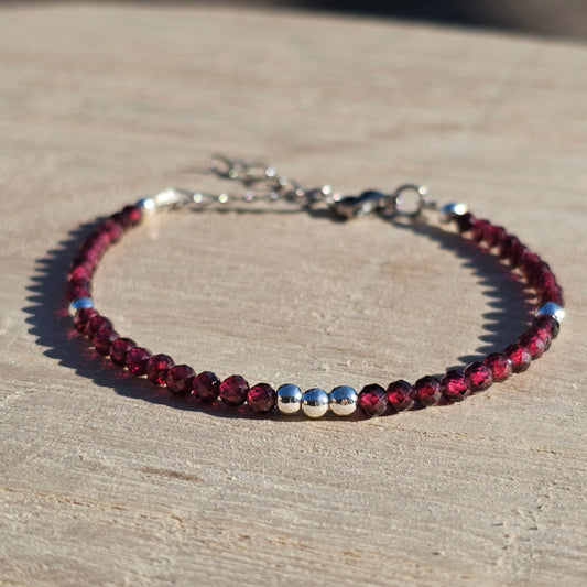 Delicate, faceted dainty AA grade Garnet and AAA grade silver plated Hematite bead bracelet with a silver stainless steel clasp and extender chain.