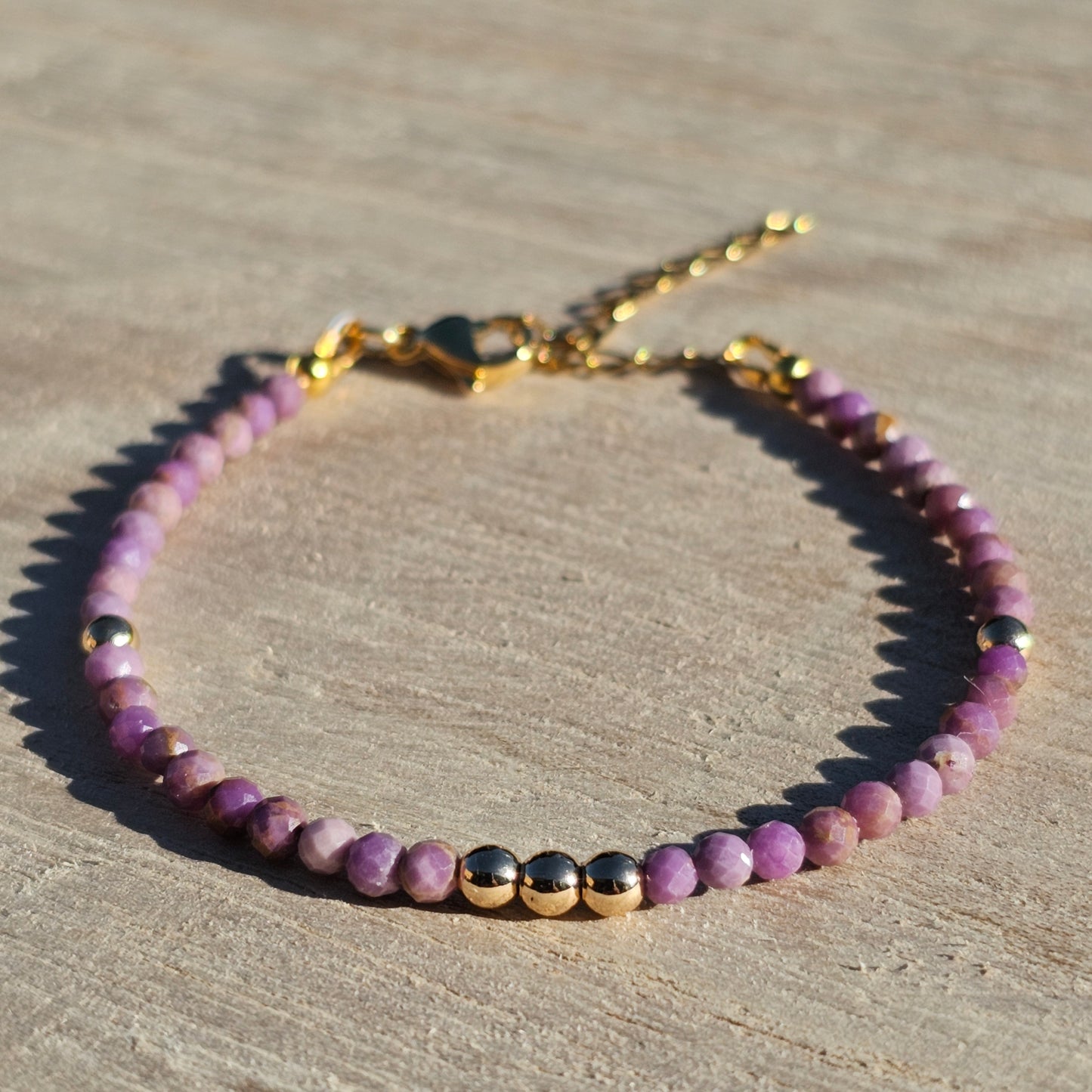 Delicate, faceted dainty Lavender Lepidolite and AAA grade gold plated Hematite bead bracelet with a gold stainless steel clasp and extender chain.