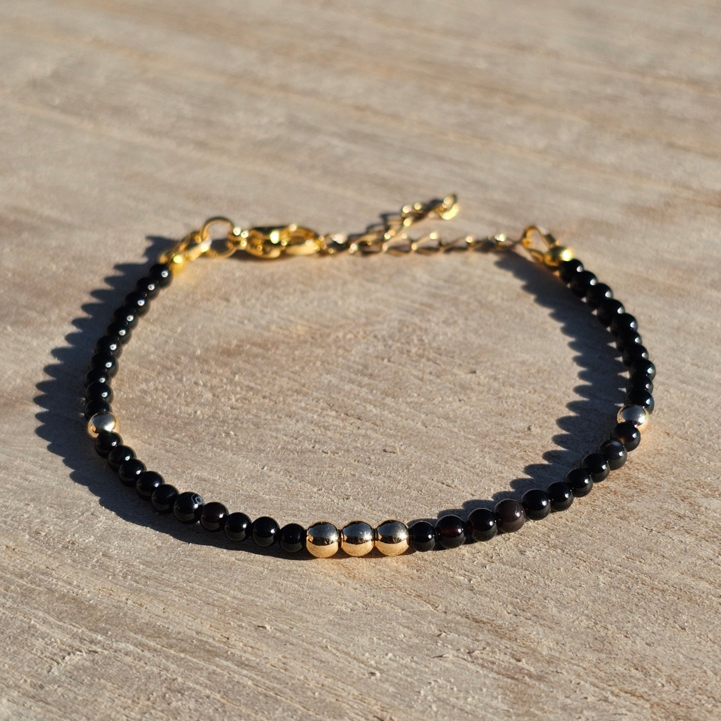 Delicate, round dainty Agate and AAA grade gold plated Hematite bead bracelet with a gold stainless steel clasp and extender chain.