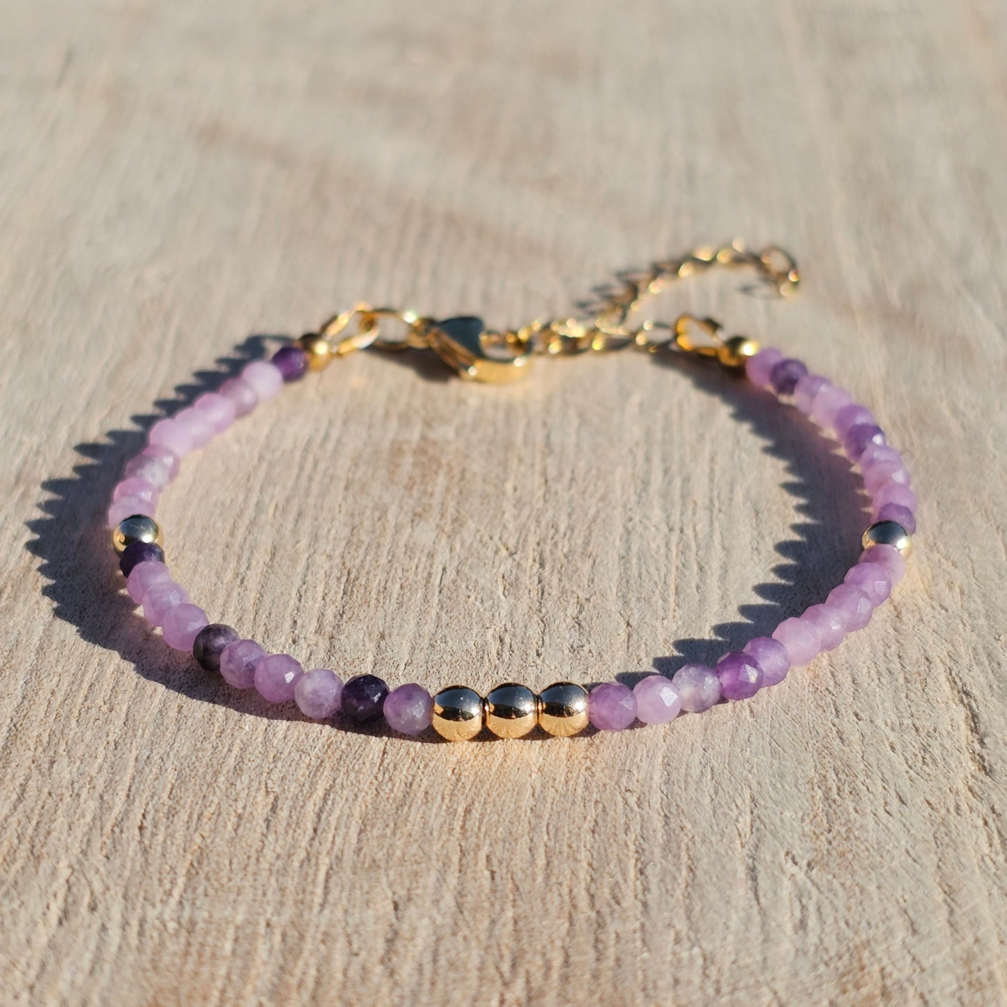 Delicate, faceted dainty Lepidolite and AAA grade gold plated Hematite bead bracelet with a gold stainless steel clasp and extender chain.