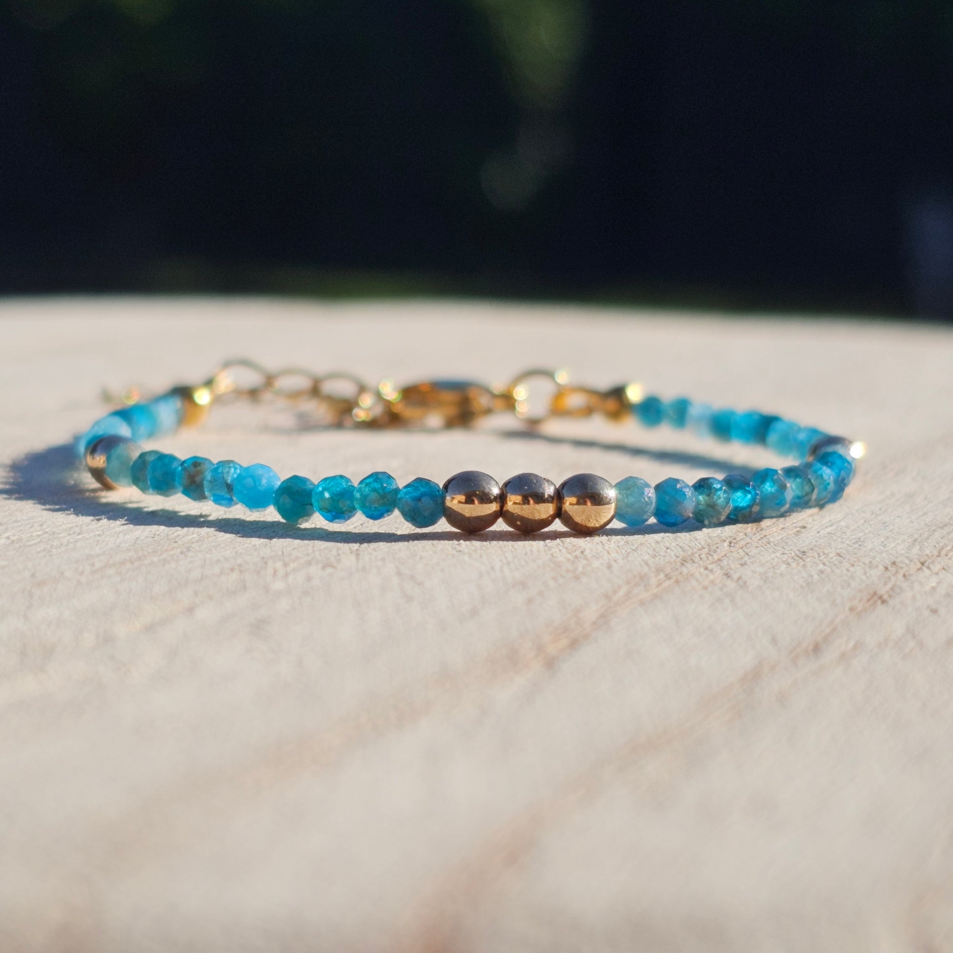 Delicate, faceted dainty AA grade Blue Apatite and AAA grade gold plated Hematite bead bracelet with a gold stainless steel clasp and extender chain.